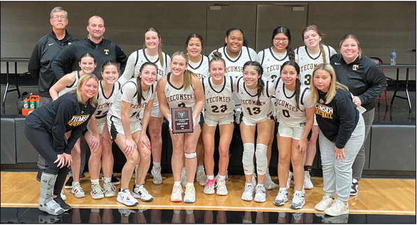 The Tecumseh Lady Savages and their coaches and managers pose with their plaque after winning third place at The Mother Road Classic, held at Verdigris on Jan. 5-7. The Lady Savages beat Coweta in overtime, 39-36; lost to Verdigris, 33-40; and won against Will Rogers, 52-49. Photo provided.