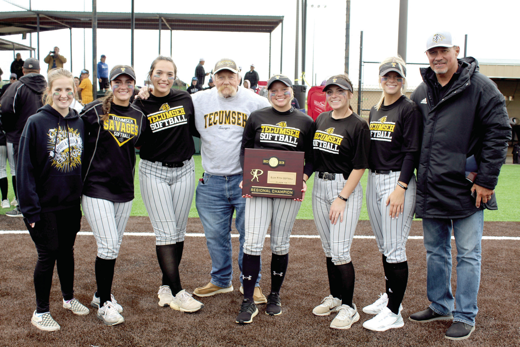 Tecumseh High School Principal Randy Dilbeck, center, and Athletic Director Jeff Shafer, far right, pose with the Lady Savage Seniors after the Class 5A Regional Championship on April 28 at FireLake Ball Fields. Shown are, Steeli Mitchell, Taylor Gage, Blakeley Sanchez, Dilbeck, Cadence Oliver, Bristin Hayes, Katelyn Fleming and Shafer. Countywide & Sun/Natasha Dunagan