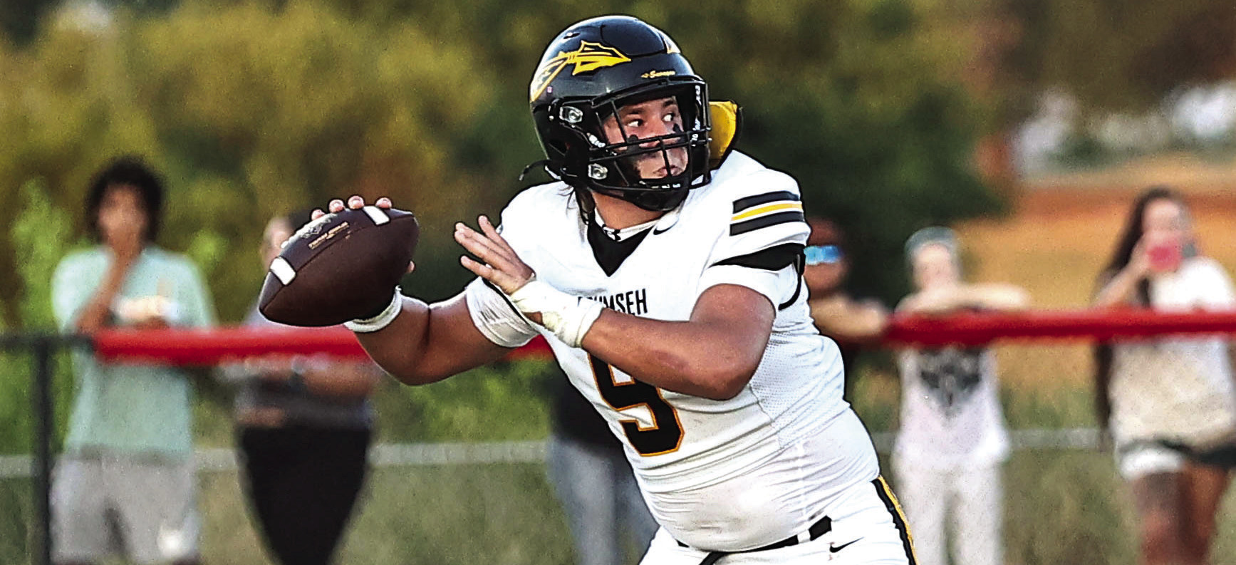 Tecumseh's Cooper Laughlin looks down field for a receiver in the loss against North Rock Creek on Aug. 28. Photos courtesy of Gowin Photography
