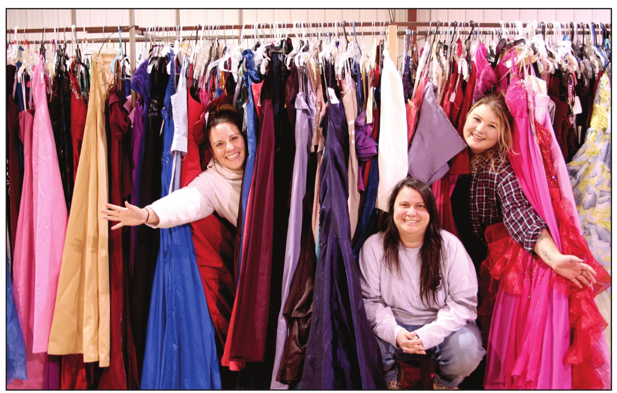 Say Yes To The Prom Dress event coordinators Jessica Hernandez, Okie Dokie Mercantile &amp; Co’s Christina Hernandez, and Cassie Low hide among racks of dresses they were sorting in preparation for the event. The pop up dress closet will provide high school students with approximately 1,500 free dresses to choose from for prom, during the three day event, March 18-20. Countywide &amp; Sun/Kendra Johnson
