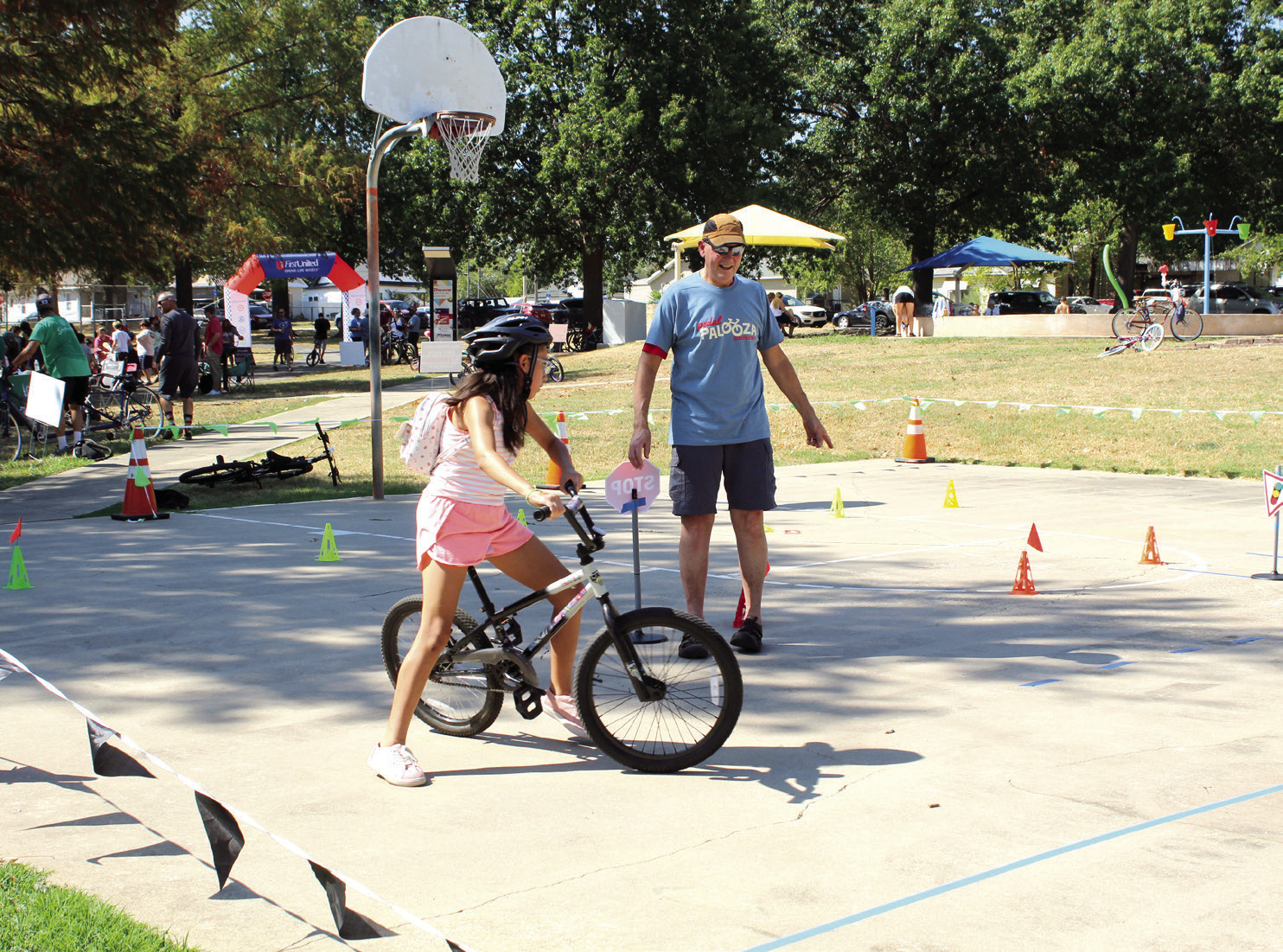 Pottawatomie Go (POGO) volunteer Craig Walker directs M'Chylah Walker, 11, where to go on the bicycle obstacle course. Photos by Natasha Dunagan, Countywide & Sun