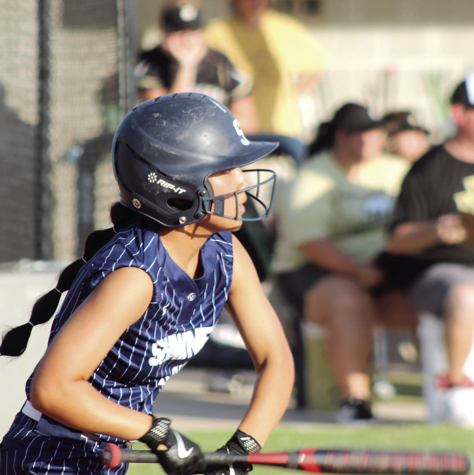 Shawnee's Clarissa Lena hits a double and hops onto second base during the second inning of the Aug. 20 home game against McAlester. The Lady Wolves won, 13-2, and have a record of 4-2 so far. Photos by Natasha Dunagan, Countywide & Sun