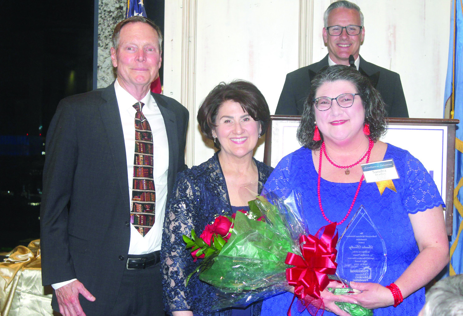 Shawnee teacher Sandra Bradley, far right, poses with Mike and Ginger Tinney after accepting the 2024 Jonathan Tinney Special Educaton Educator Merit Award at the Professional Oklahoma Educators Foundation awards ceremony in April. The award is named in memory of the Tinneys’ infant son who was born with Down’s Syndrome in 1989. Photo provided.