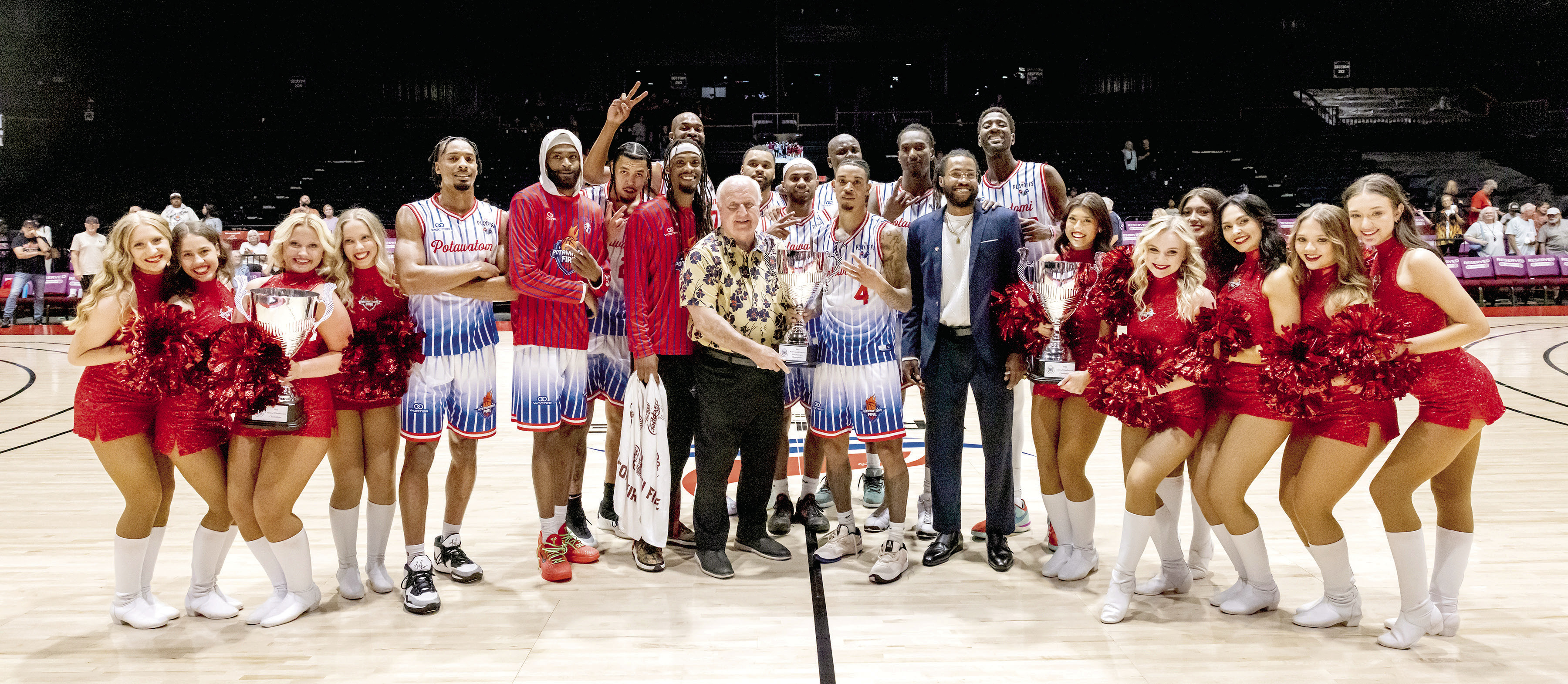 The Potawatomi Fire and the Fire Girls pose with Citizen Potawatomi Nation Chairman John 'Rocky' Barrett, their latest Midwest/Central Conference Championship trophy, won on June 7, and the two MCF trophies from the last two years. They will move on to the Western Regional Finals against Great Falls Electric, June 12 (away) and June 15 (FireLake Arena). Photo courtesy of Kent Bush, CPN