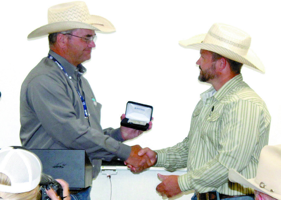 IPRA/IFYR General Manager Dale Yerigan presents a Montana Silversmith credit card holder to Dr. Alex Simpson who has served as the veterinarian on-call at the IFYR for 10 years. Natasha Dunagan, Countywide & Sun