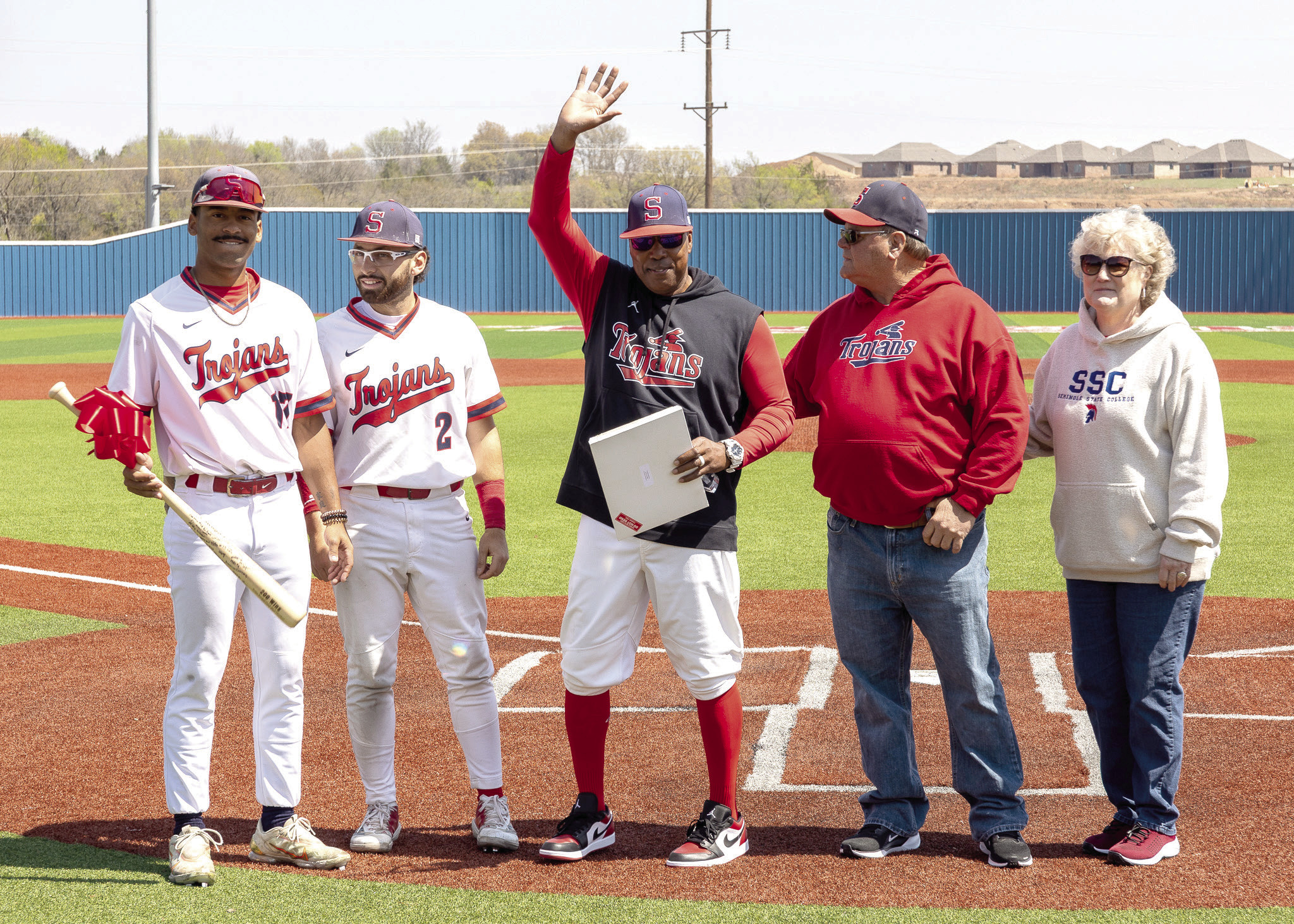 Pictured from left, SSC sophomores Kendall McDowell and Wilfred Gonzalez, Head Coach Mack Chambers, Board of Regents Chair Curtis Morgan and President Lana Reynolds gather on Lloyd Simmons Field to honor Chambers for his 200th win as head coach of the Trojans. Photo provided