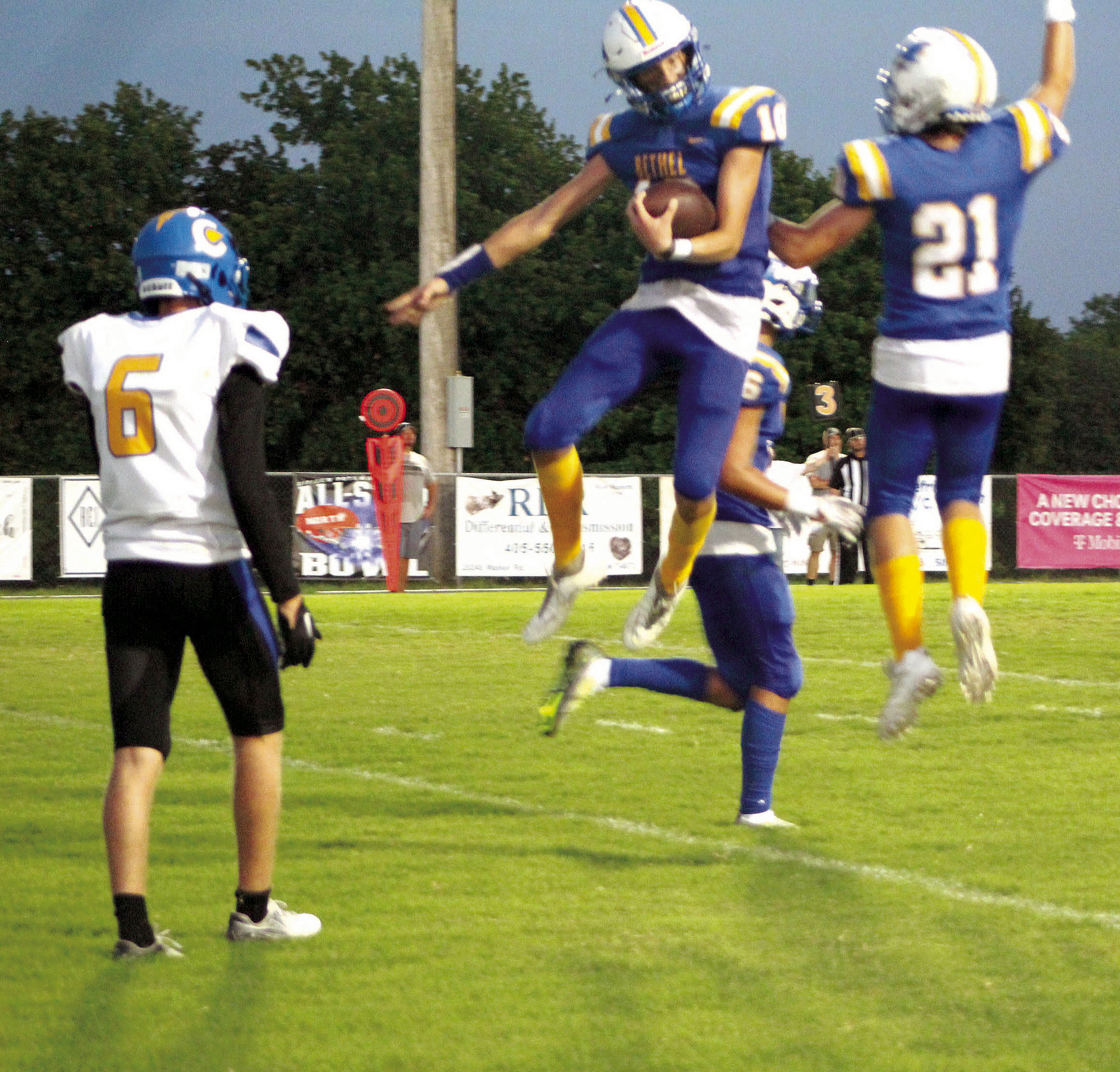 Bethel juniors Reagan Curry (#10) and R.J. Morris (#21) jump in celebration of Curry receiving the ball in the end zone for a touchdown during the season opening home game on Sept. 2. Bethel won 43-12. Countywide & Sun/Natasha Dunagan