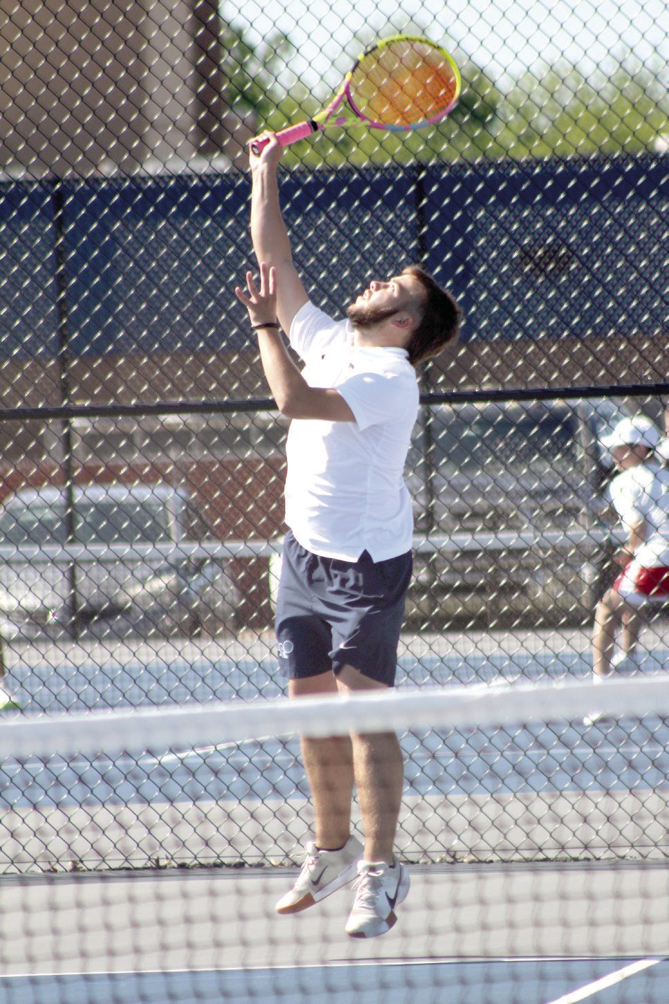 Shawnee junior Bryce Comstock, on #1 Doubles with junior Benji Cole, serves during the Shawnee NGB (National Governing Body) Tournament on May 3. They were playing against Tecumseh. Photos by Natasha Dunagan, Countywide & Sun