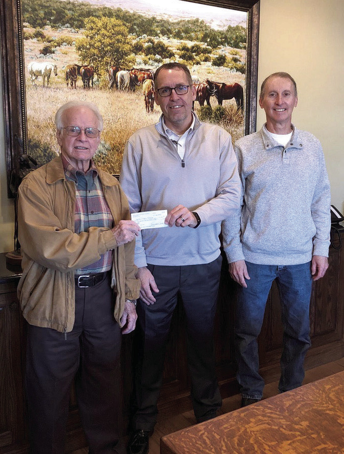 Bethel Superintendent Matt Posey accepts a $6,500 check from Pottawatomie County Facilities Authority Chairman Leonard Taron, left, and Vice-Chair Tom Wilsie at West Law Firm in Shawnee. Bethel Public Schools plans to use the money for signage on their campuses, including their new Upper Elementary. Photo provided.