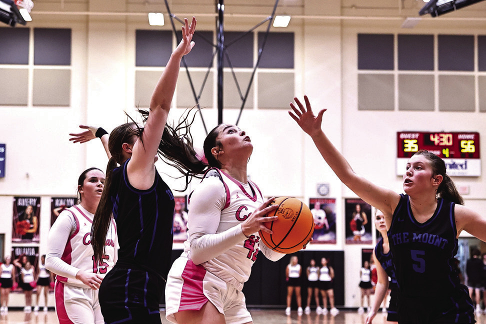 Tuesday, Jan. 30 was North Rock Creek’s pink out night against Mount St. Mary. Sarah Campbell goes between two defenders for the shot. Girls won 66-41.