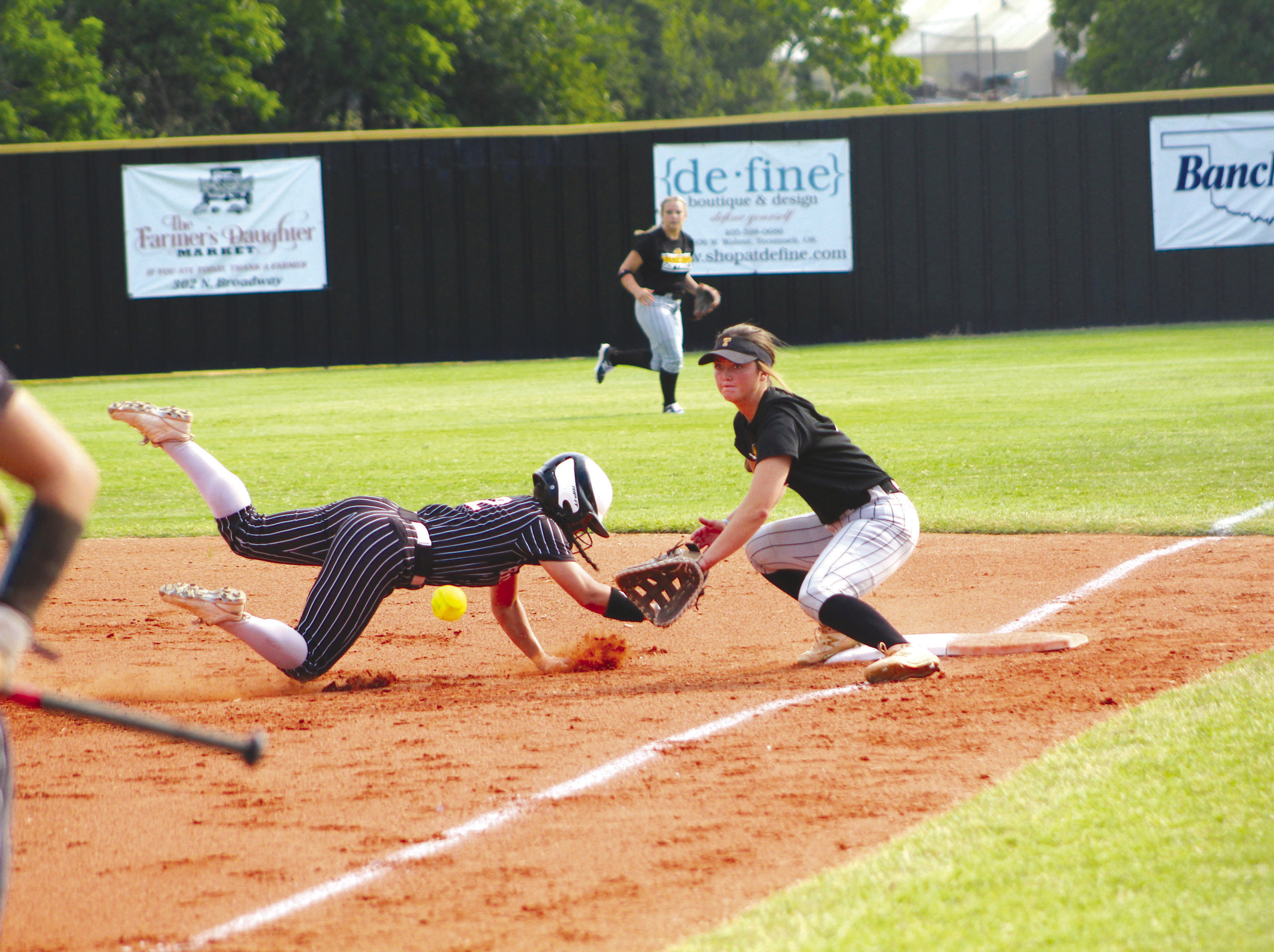 Tecumseh junior Jessi Hull guards first base and prepares for the catch as a Perkins-Tryon runner dives back to safety in the second inning of the home game on Aug. 7. Tecumseh won their first game of the fastpitch season, 15-1. Countywide &amp; Sun/Natasha Dunagan