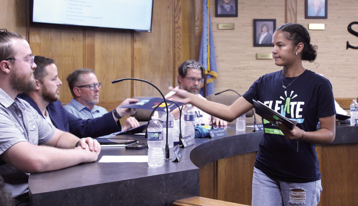 Shawnee High School sophomore Khloe Tungate hands out literature on the Elevate Student Health Campaign to the Shawnee Public Schools Board of Education at their Oct. 6 meeting. Natasha Dunagan, Countywide &amp; Sun