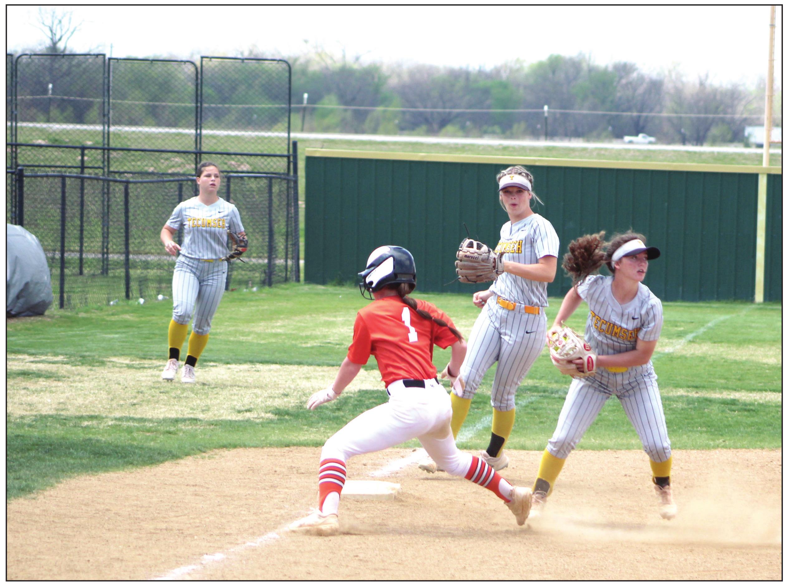 Tecumseh freshman and pitcher Jessi Hull, far right, tags a runner out at third base and turns to throw it to a teammate, as Katelyn Fleming, center, guards her base during the Dale Slowpitch Festival game against Sterling on April 15 at the FireLake Ball Fields.The Lady Savages won in the fourth inning, 10-0. Countywide &amp; Sun/Natasha Dunagan