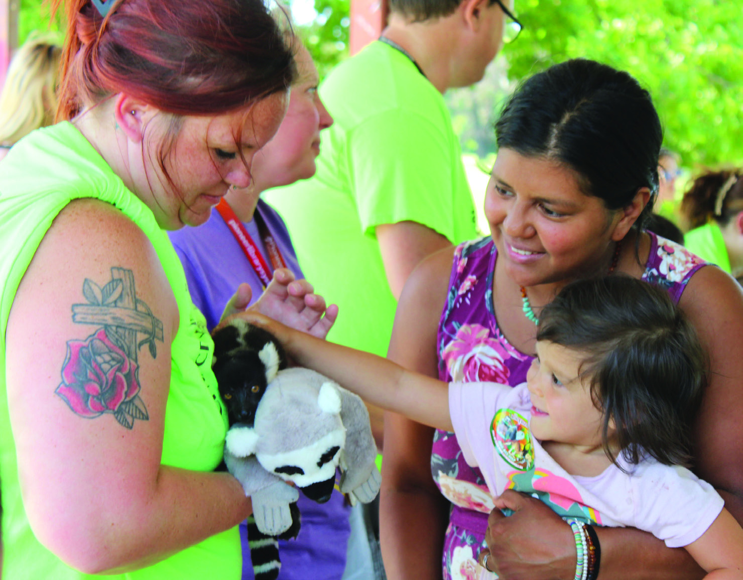 Rhema Brynildsen, 3, is held by her mother, Katrina Brynildsen, both of Tecumseh, as she pets Mort the baby Black-and-White Ruffed Lemur during the Tecumseh Pioneer Library Summer Reading Challenge Extreme Animals program on June 13. This is one of 60 species of lemur found in Madagascar, said handler Keeley Knowles, who also spoke on Burmese pythons, bearded dragons, blue-tongued skinks, European hedgehogs and armadillos. Holding Mort is CPN/CDC After-School Program teacher Kristen Janway.