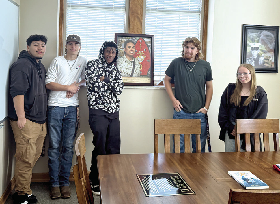 Earlsboro students pause from their County Buildings Tour to pose with a photo of HN (FMF) Eric D. Warren, the son of one of their teachers. Warren passed away on May 26, 2012, while serving in Afghanistan; he was 23 years old. Photos by Julie Talton, Countywide & Sun