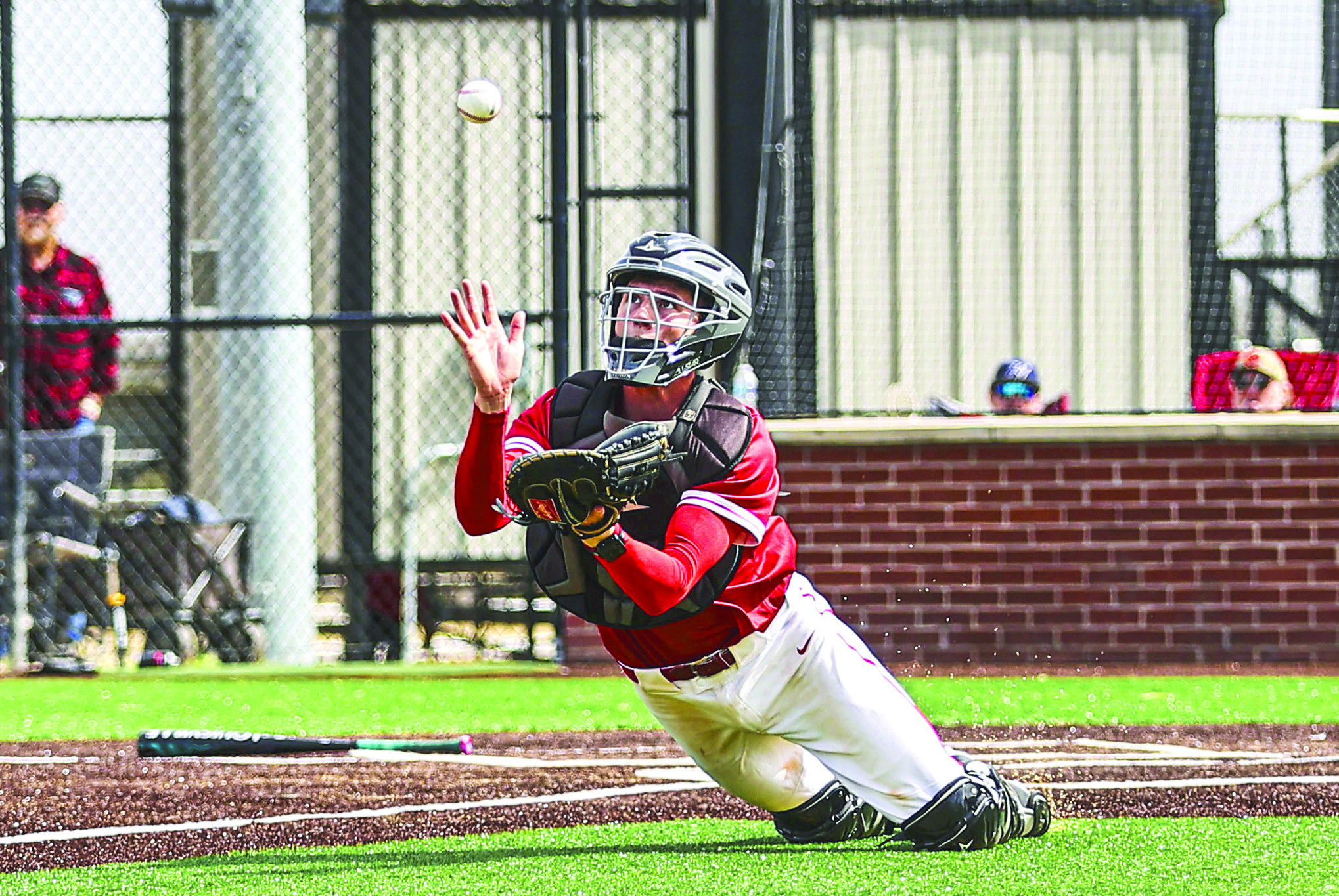 North Rock Creek's catcher Landon Rosser, made a great diving catch for the out. NRC came up short in the fi rst game of the NRC festival against Heritage Hall, losing 3-6. They came back in the second game against Harrah, winning 8-0.