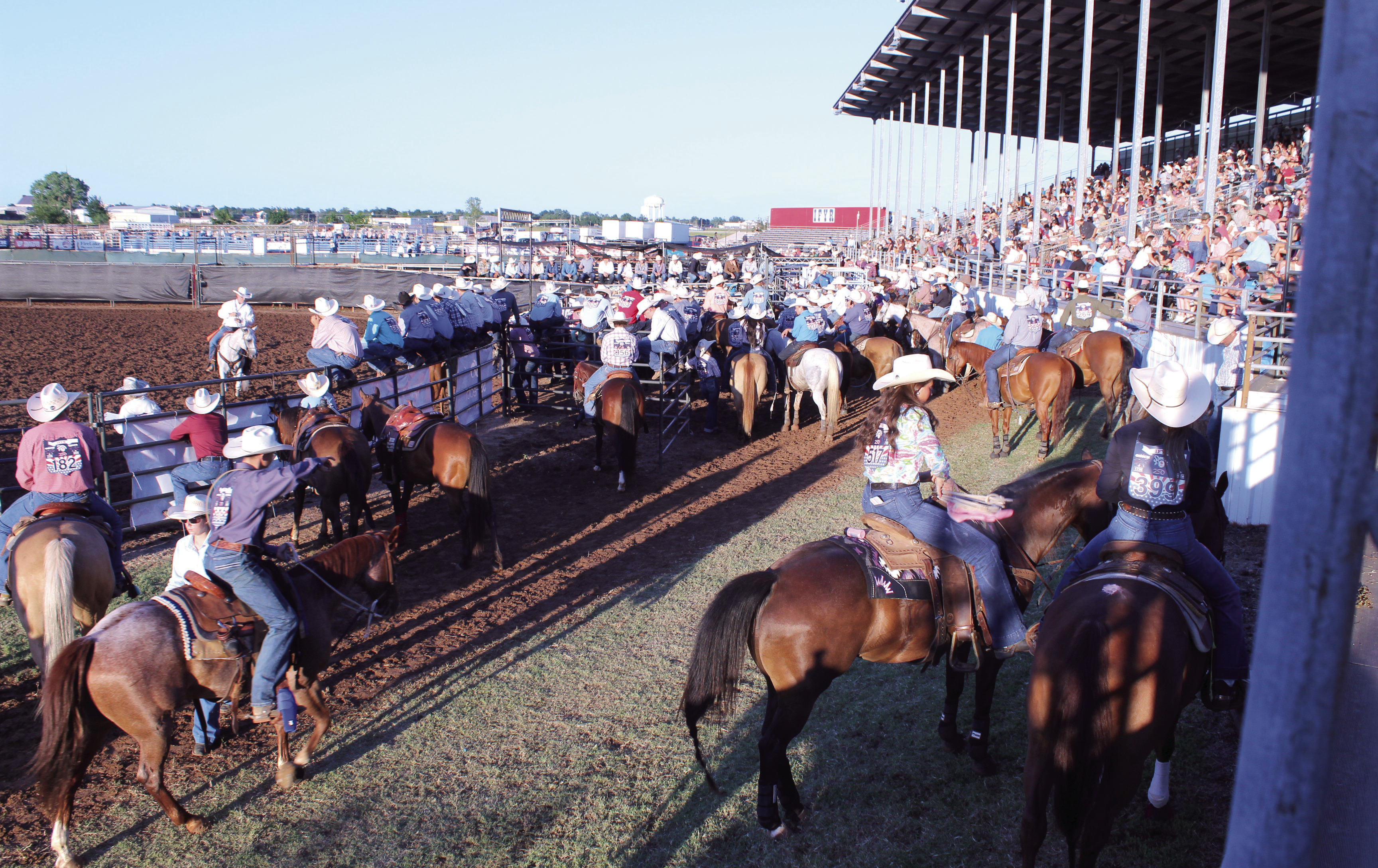Contestants for the International Finals Youth Rodeo wait for their events, as a packed house watches, on opening night, July 12, at the Heart of Oklahoma Expo Center in Shawnee. There are 937 contestants from 38 states and three countries this year. See more photos on A11. Natasha Dunagan, Countywide &amp; Sun