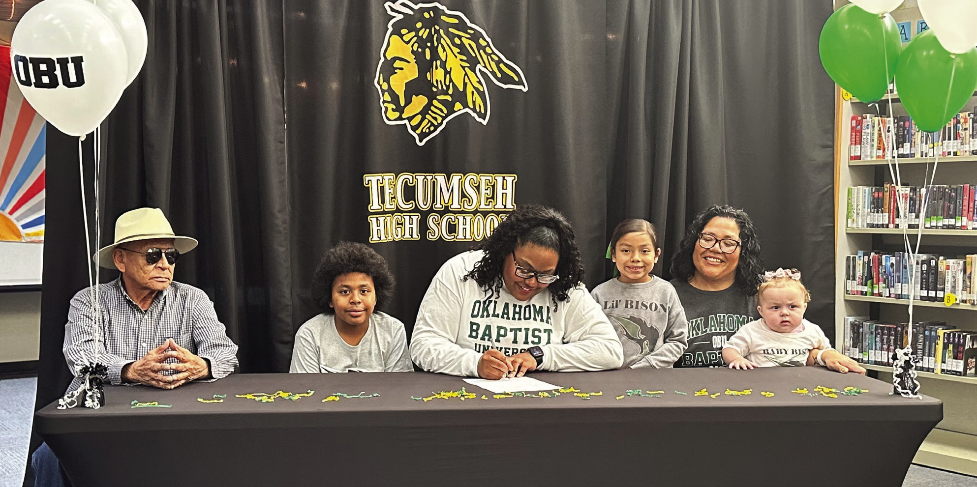 Tecumseh senior Kiara Stallin, center, signed a letter of intent with Oklahoma Baptist University for track on March 5. Stallin is shown with her family, from left, Tommy Kaskaske, Keelym Parks, Aniyah Masquas, Fallon Jackson and Makayla Allen. Photo provided by Casi Bays.