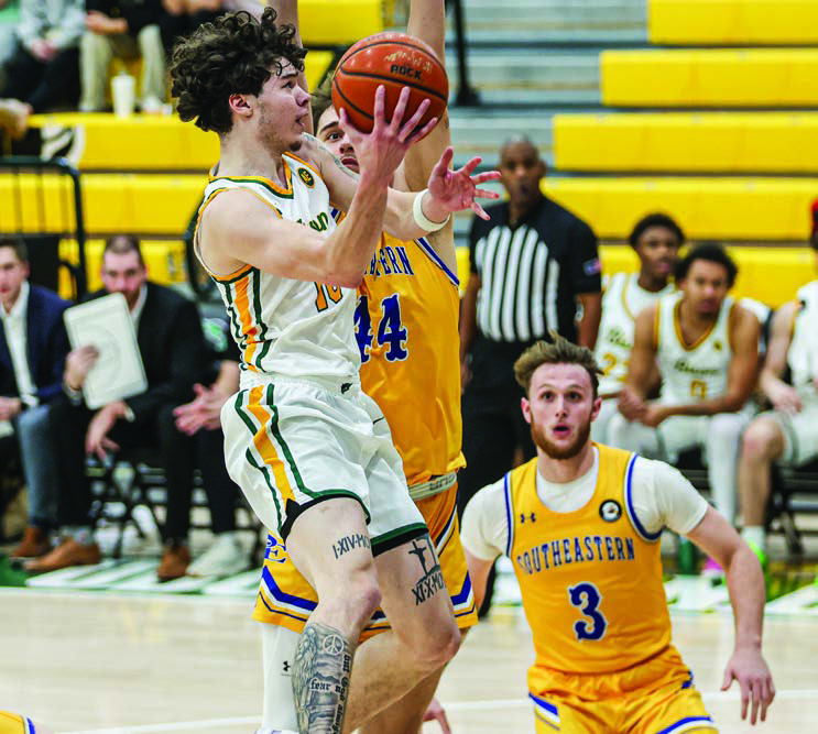 Oklahoma Baptist University’s JC Curry goes for the shot among three Harding defensive players in the win Saturday, Jan. 11. The Bison take on Ouachita in a home game tonight (Thursday, Jan. 16). Tipoff is scheduled for 7:30 pm. Photo provided by OBU