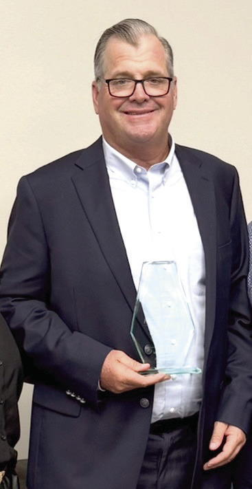 Tecumseh Lady Savage Fast Pitch Head Coach Chad Trahan poses with his Oklahoma High School Fastpitch Softball Coaches Association Hall of Fame award. Photo provided