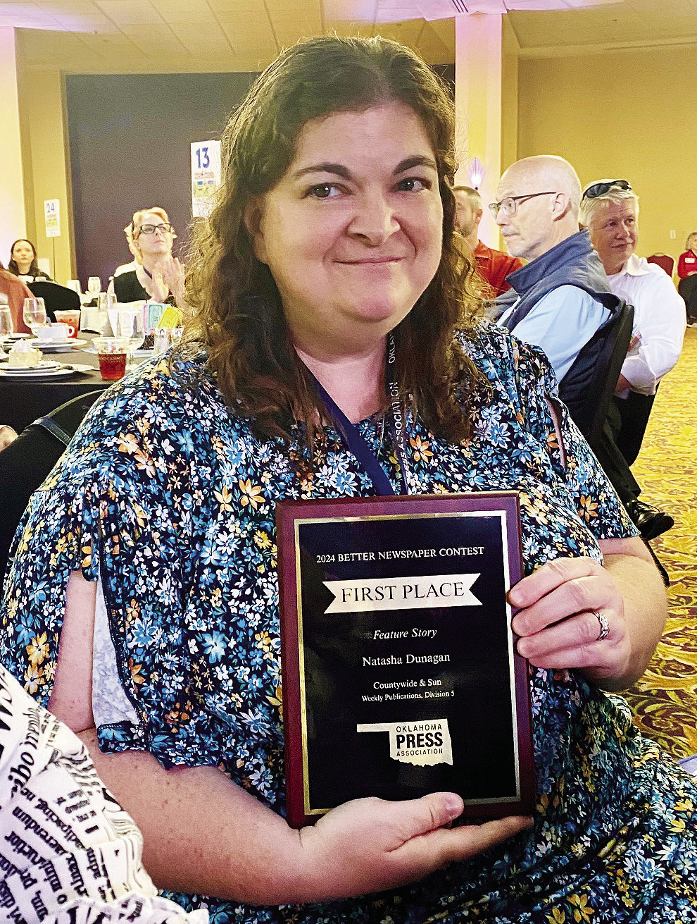 Natasha Dunagan poses with her first place Feature Story plaque at the OPA Awards Convention last weekend. 'I love writing feature stories. It is my way of helping get someone's story out to the public. It feeds the kid in me who loved listening to the grownups talk. I've always been curious about life stories.' Julie Talton, Countywide & Sun