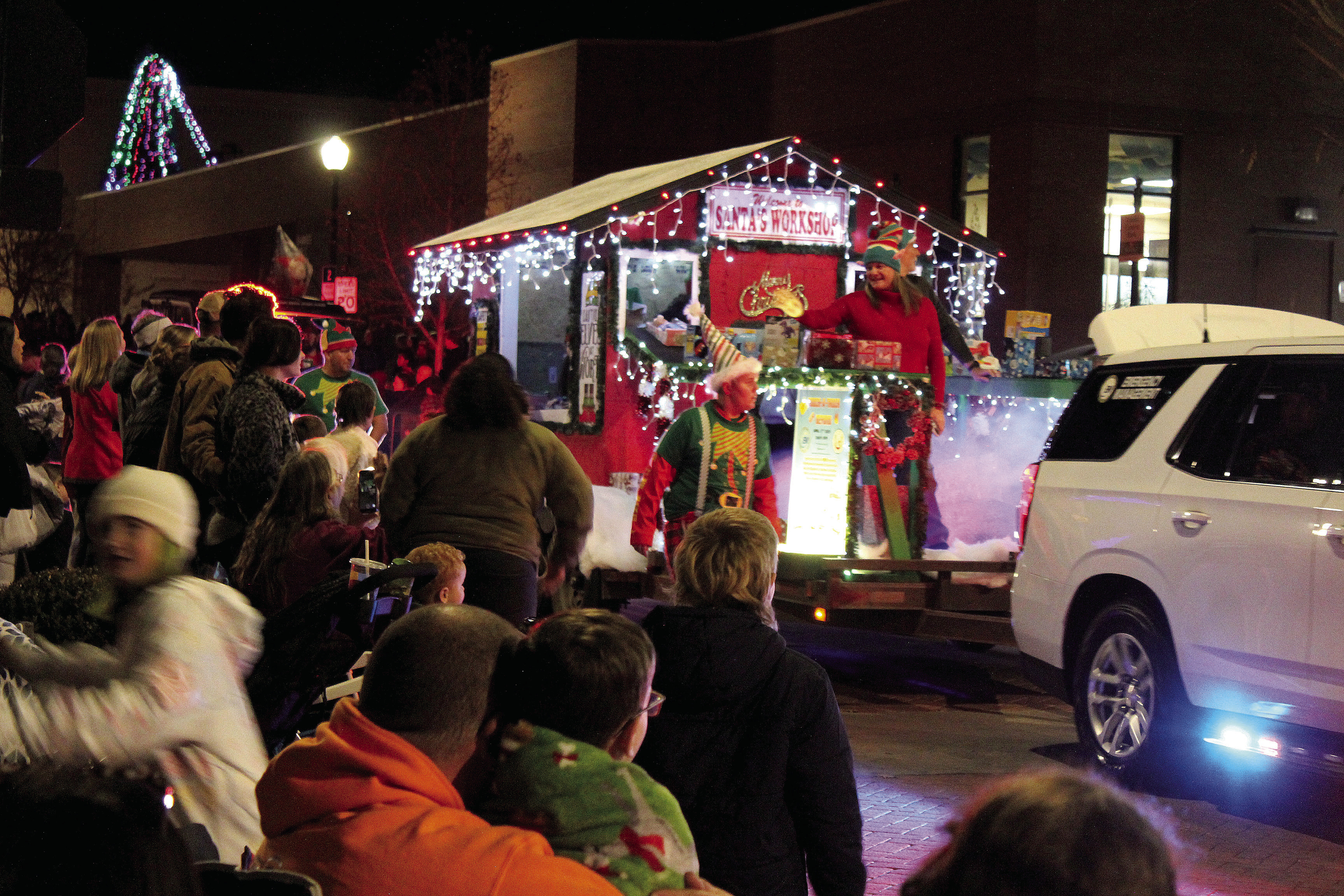 Volunteers and employees of Emergency Management of Pottawatomie County ride on or walk beside their Santa’s Workshop float in the Shawnee Christmas Parade on Dec. 8. Countywide & Sun/Natasha Dunagan