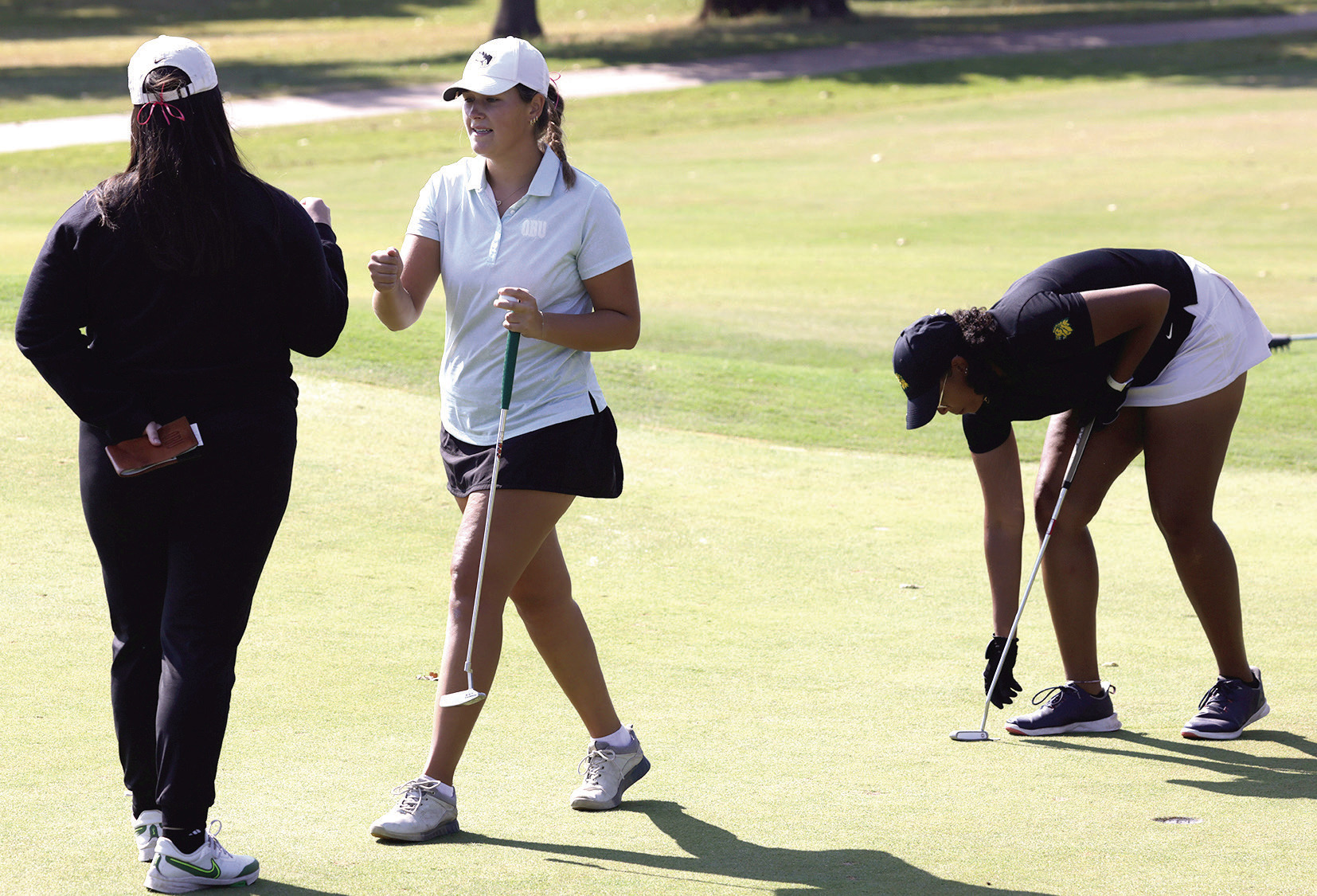 Oklahoma Baptist University senior Rylie Spaulding does a quick fist bump after a successful putt. Photo provided by OBU