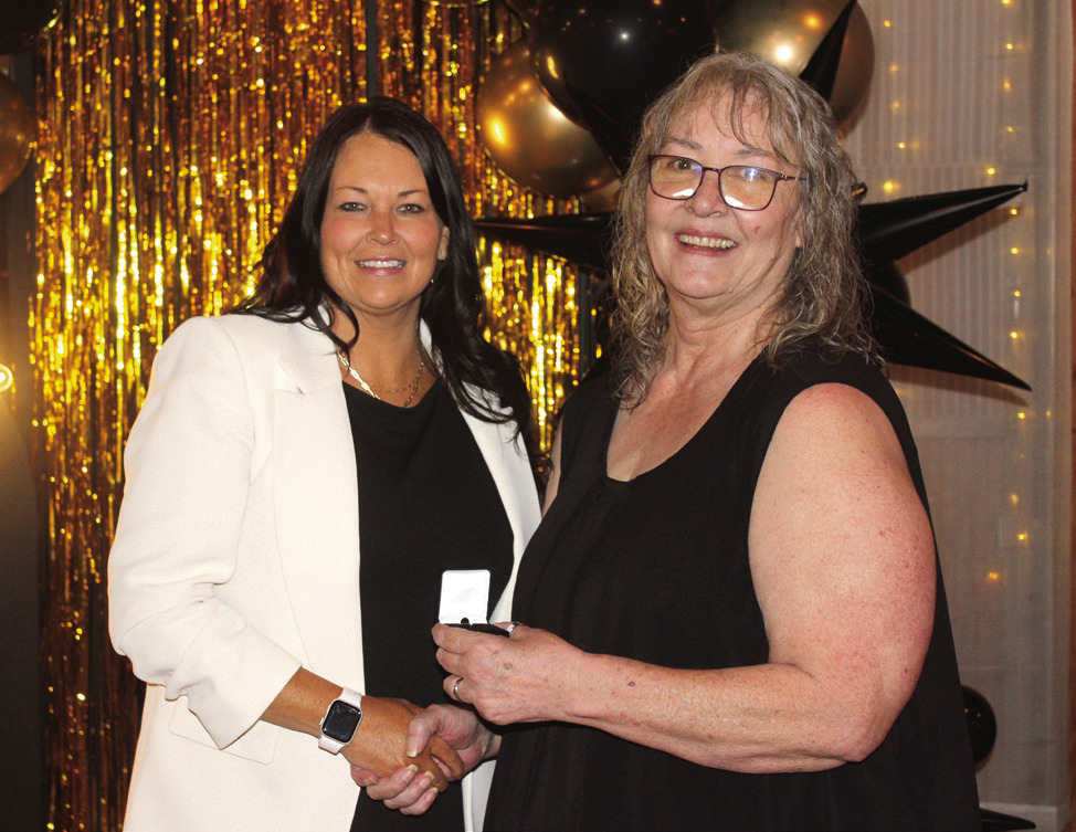 Countywide & Sun Owner and Publisher Suzie Campbell, right, presents a Pottawatomie Power Poll Top 10 lapel pin to Ashley Fichtner during the Awards Gala on Oct. 24. Natasha Dunagan, Countywide &amp; Sun