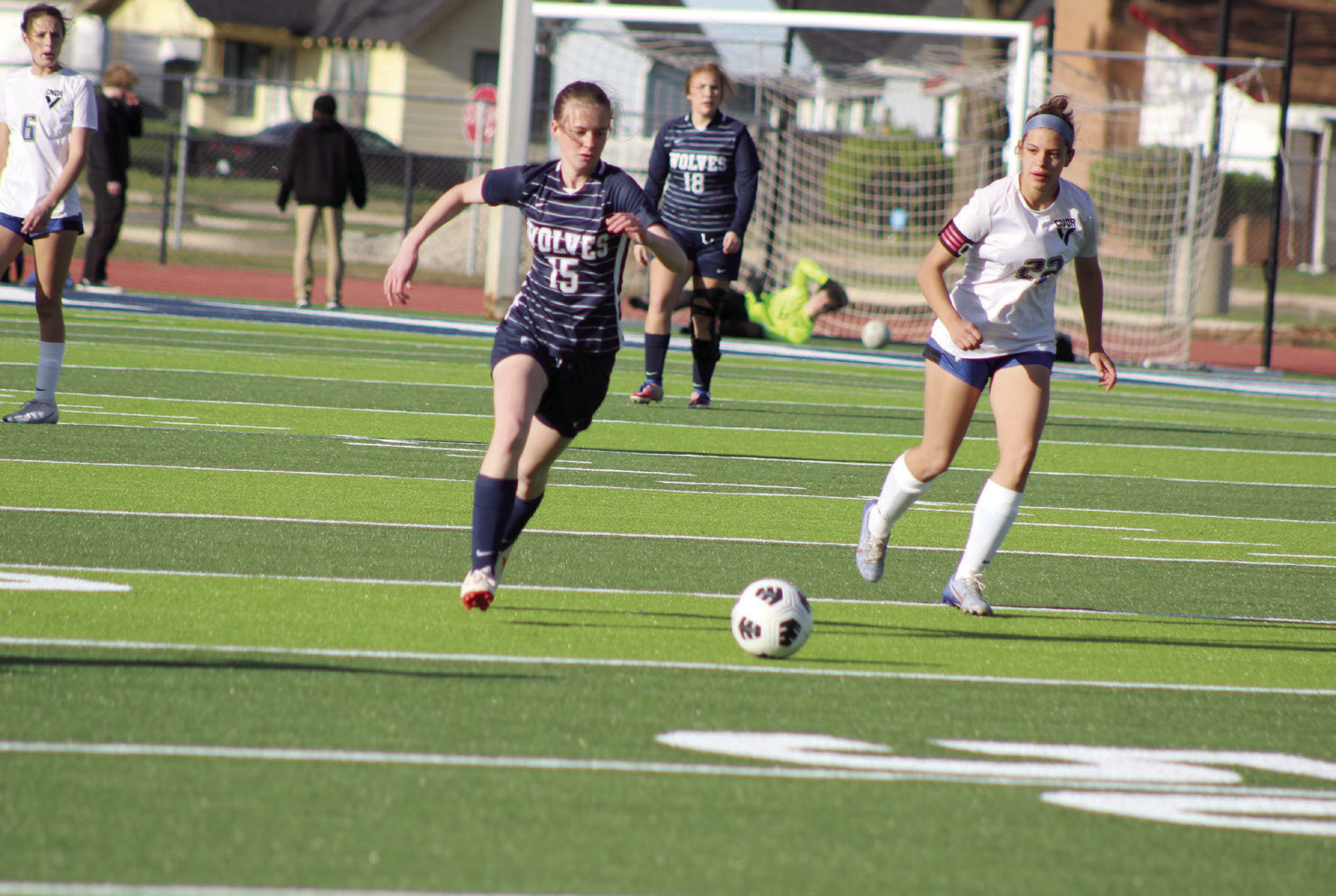 Shawnee’s Kiley Sartin prepares to pass the ball before a Victory Christian player takes possession, as teammate Deanna Pack (#18) looks on during the home game on April 2.