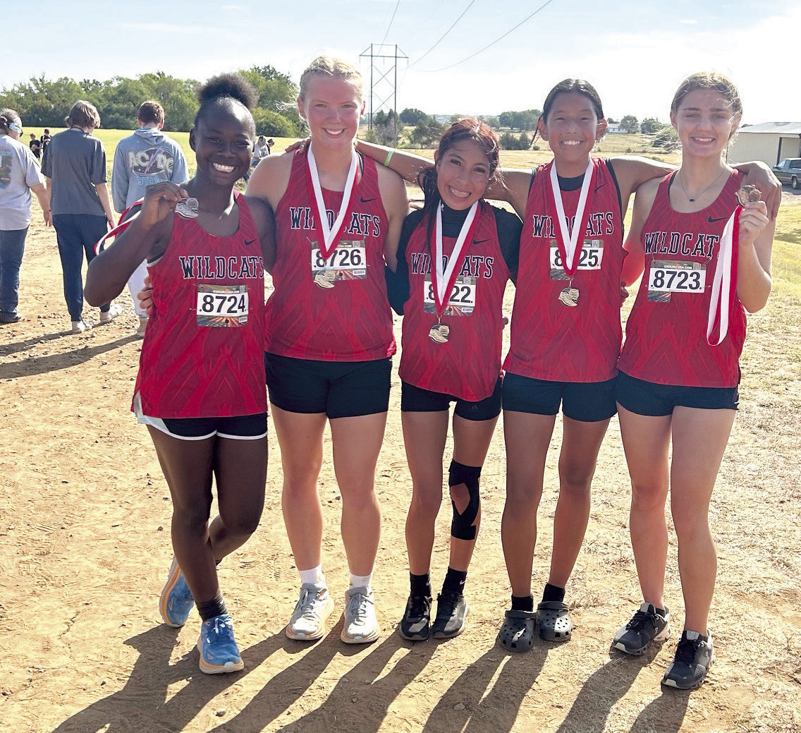 Pictured from left are Zeaonna McGregor, Peighton Worley, Karmalea Howell, Aha Roubidoux, and Xalina McCarroll. For the second week in a row, the EHS Lady Wildcats claimed Runner Up in The Heartland Championship cross country race held at North Rock Creek, and all five team members medaled. Freshman Peighton Worley took seventh, sophomores Karmalea Howell and Aha Roubidoux placed eighth and ninth, respectively. Freshman Zeaonna McGregor placed 11th and junior Xalina McCarroll placed 15th.