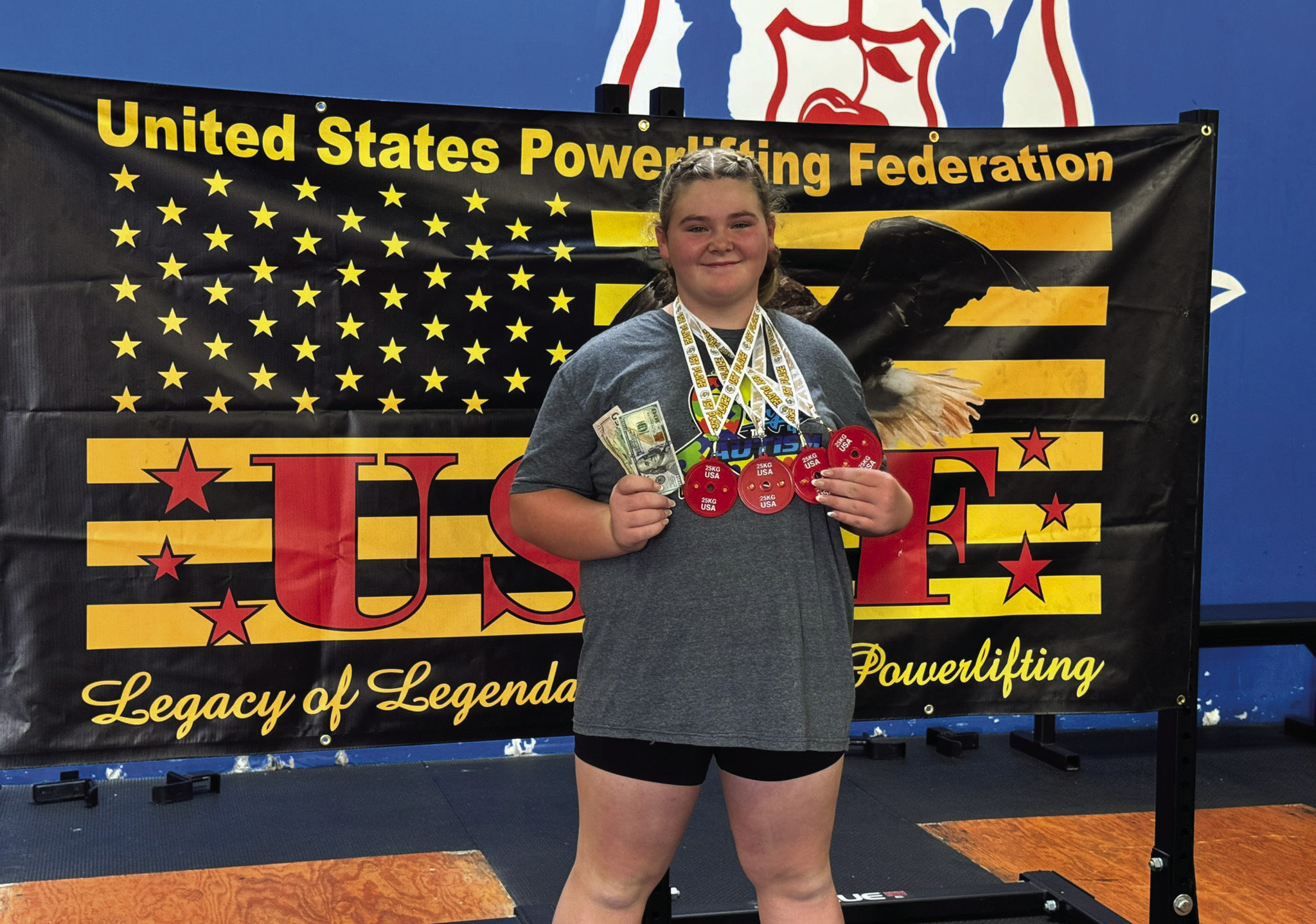 Colleen Williams, 12, of Dale, poses with her prize money and medals after breaking a world powerlifting record of a combined 742 pounds at the United States Powerlifting Federation competition in Denver, CO on Aug. 25. Photo provided.