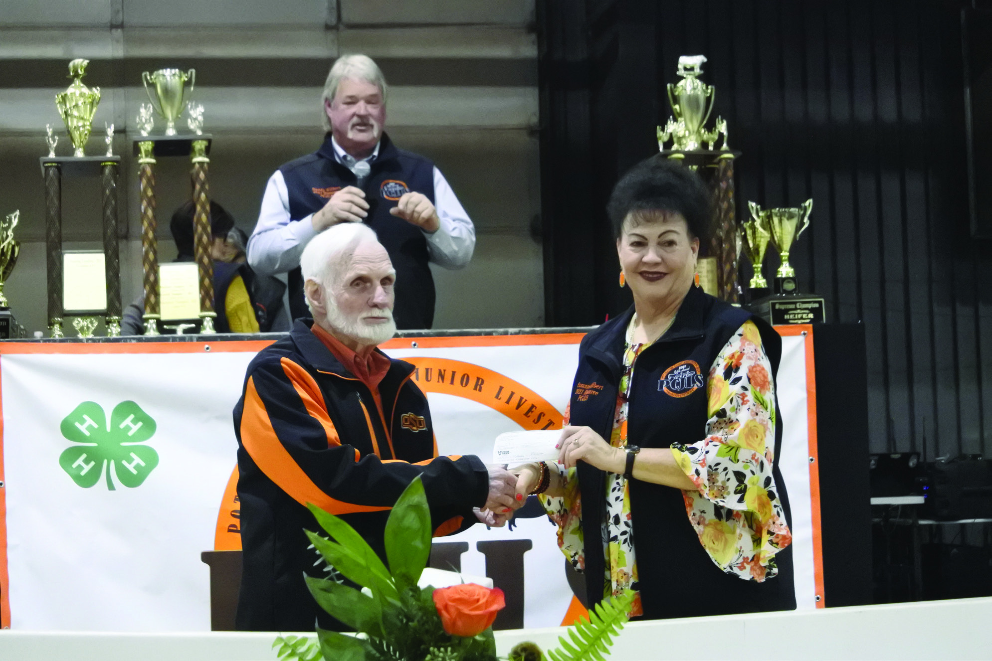Dr. Joe Taron presents a $10,000 check to Suzanne Gilbert for the PCJLS Scholarship Foundation whie Randy Gilbert talks to the audience about all the ways Taron helps and is involved in the Pottawatomie County Junior Livestock Show. Countywide &amp; Sun/Suzie Campbell