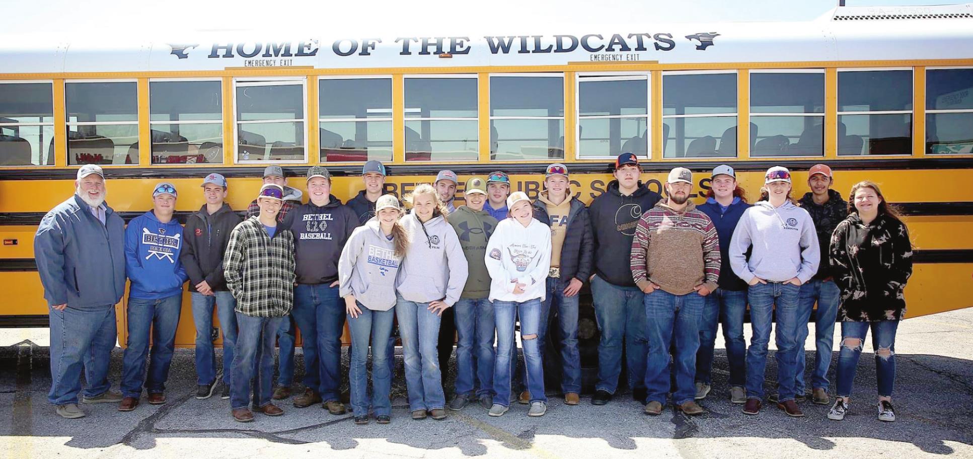 Bethel FFA Advisor Brett Scott, far left, and the Bethel FFA Shooting Team members who qualified for the OKSSSP State Competition pose by their bus before leaving for El Reno on April 13. Photo provided.