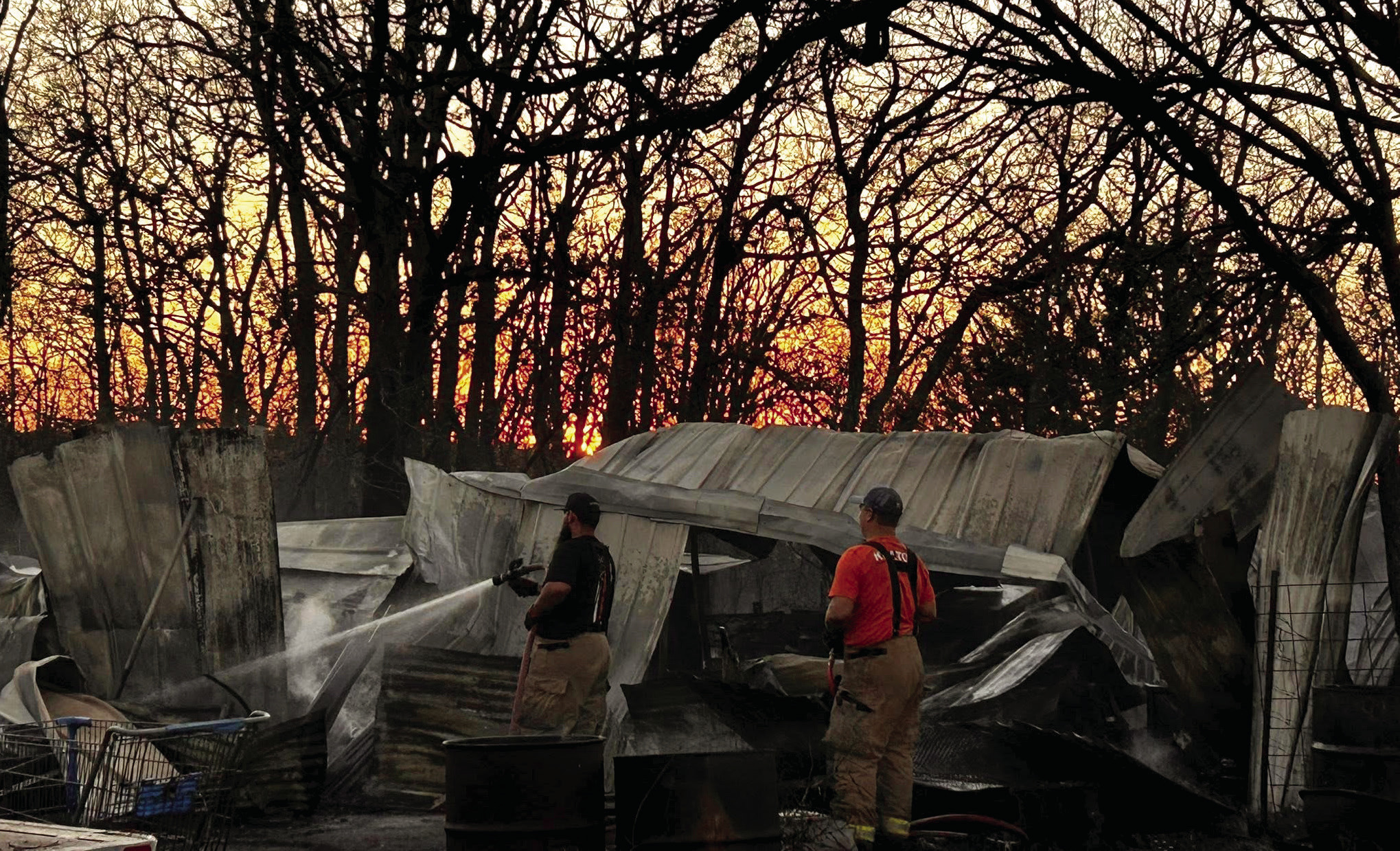 As the sun sets beyond the trees, Bethel Acres firefighters douse the hotspots of a fire on Dec. 22. With neighboring Fire Departments on scene including McLoud, Shawnee, and Tecumseh, the departments worked together to get the fire under control, saving the homes. Suzie Campbell, Countywide & Sun