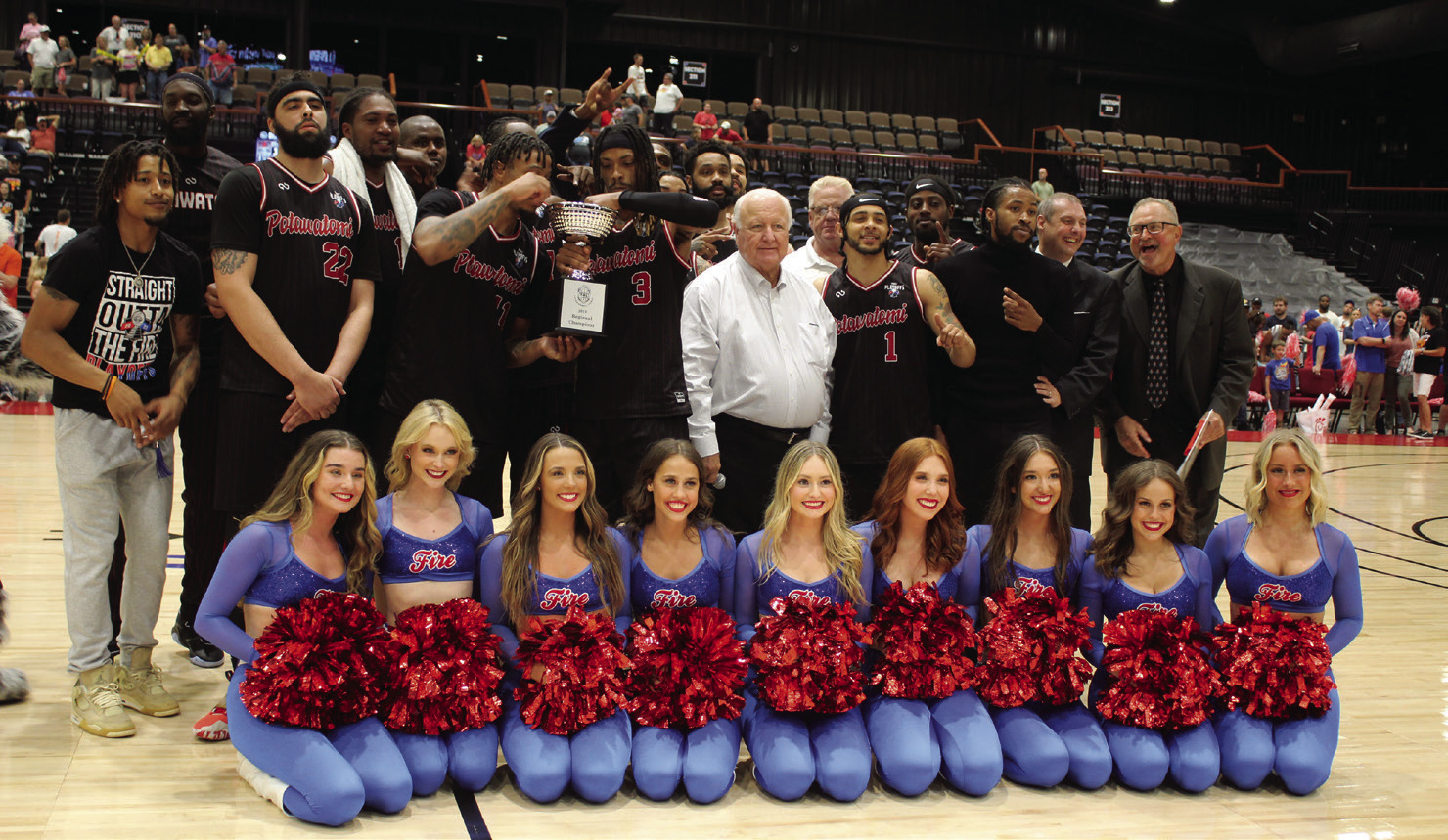 The Potawatomi Fire pose with the Fire Girls, Citizen Potawatomi Nation Chairman John "Rocky" Barrett, center, FireLake Arena Manager David Qualls, Head Coach Mark Danhoff and Assistant Coach Brad Walck after winning The Basketball League Central Conference Regionals on June 19. Countywide & Sun/Natasha Dunagan