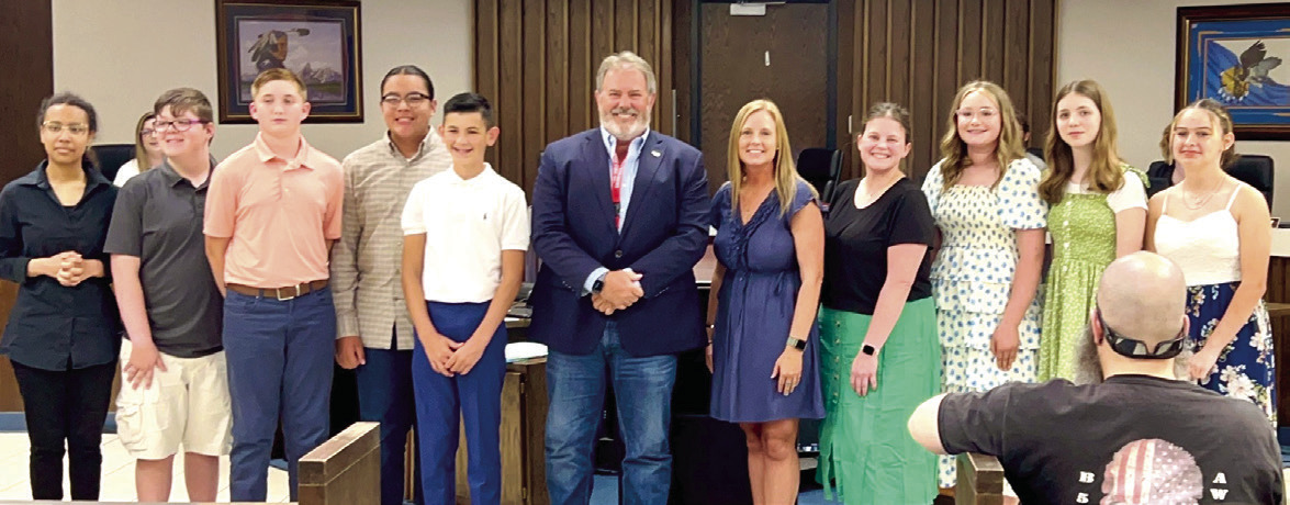 Sister City students recognized at meeting. Pictured with Mayor Eric Stephens (in no particular order) are program chair Jessica Brown, teacher Alanna Baggett, students include Sawyer Bias, Emma Bryan, Chloe Gates, Colin Howard, Matty Newsom, Keiko Sanders, Sullivan Smith, and Benjamin Wahpepah. Photo provided