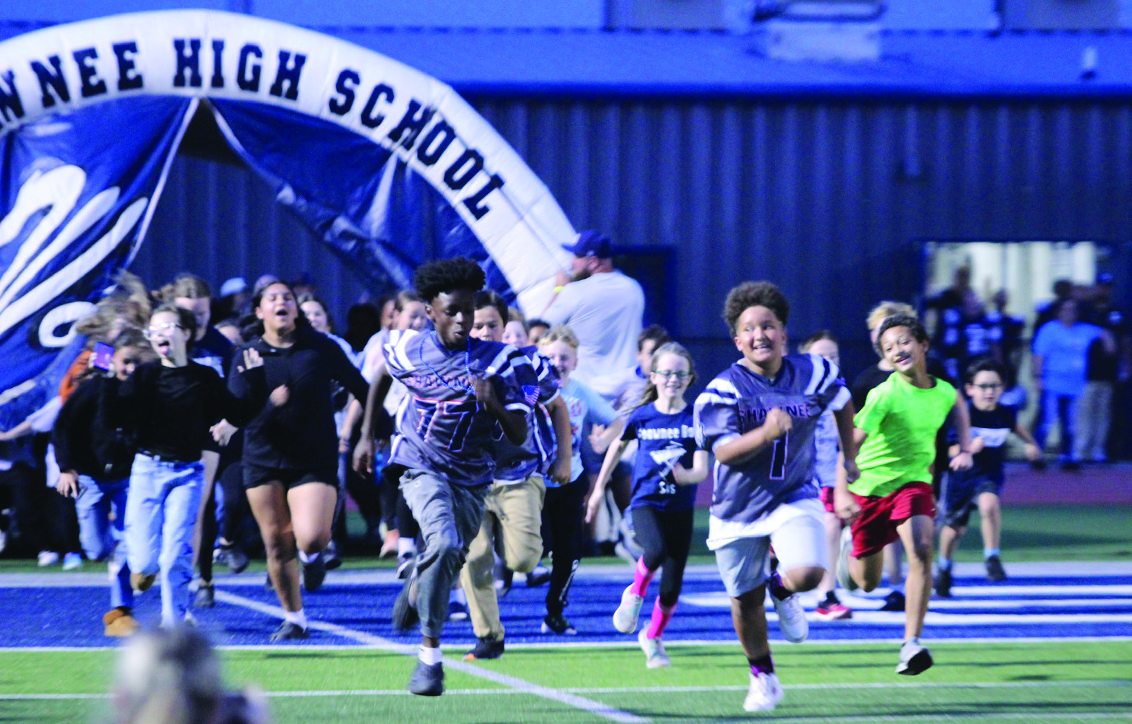 Students from Sequoyah Elementary run out of the tunnel before the Wolves football team at the Oct. 23 homecoming game against Tulsa's Edison Prep. Four students from Sequoyah were also honored during the game for perfect attendance.
