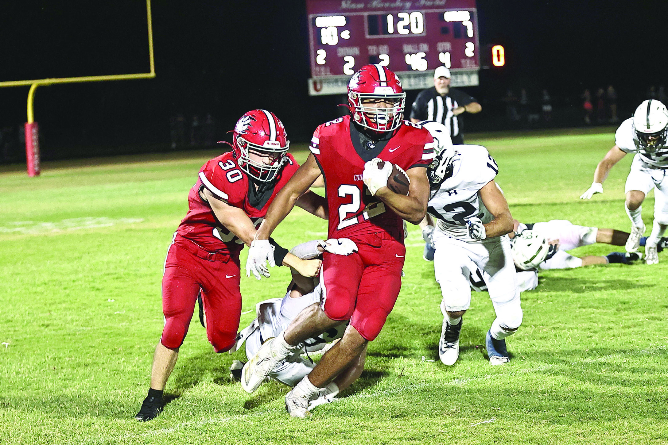 Pictured left, North Rock Creek’s Caleb Hawkins escapes two tackles and heads for the winning touchdown. The NRC Cougars opened its season Friday, Aug. 30 with a 17-7 win against Marlow.