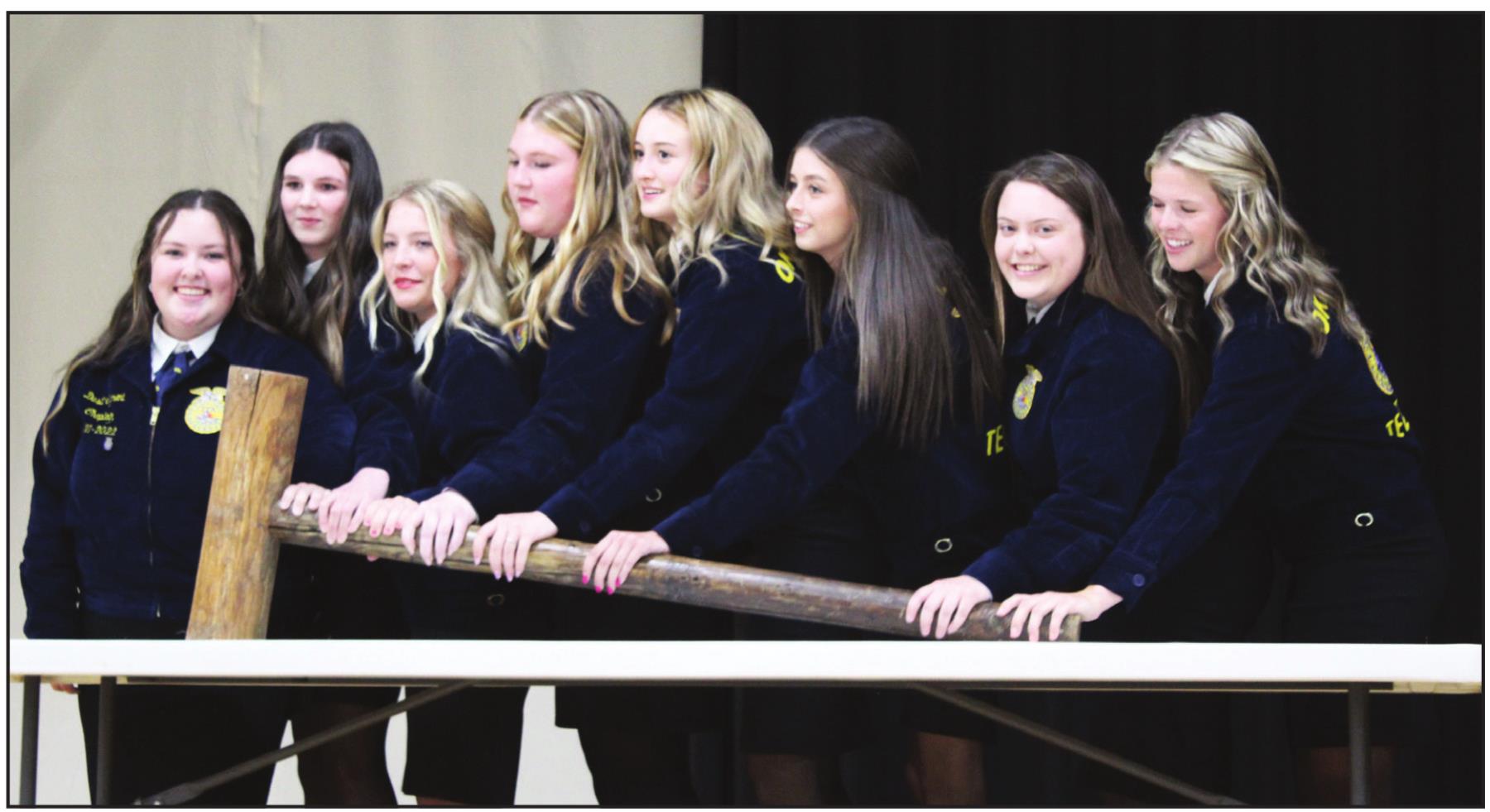 The 2021-2022 Tecumseh FFA Board members use a giant gavel to call the annual FFA Banquet to order on May 12. They are, from left, Dusti Ozment, Rylee Williams, Marli Williams, Piper Goodson, Chloe Kelsey, Jocelyn Phelps, Maci Flowers and Katelyn Fleming. After qualifying for a second time, the board reorganized, and the same members will serve again for the 2022-23 school year. Countywide &amp; Sun/Natasha Dunagan