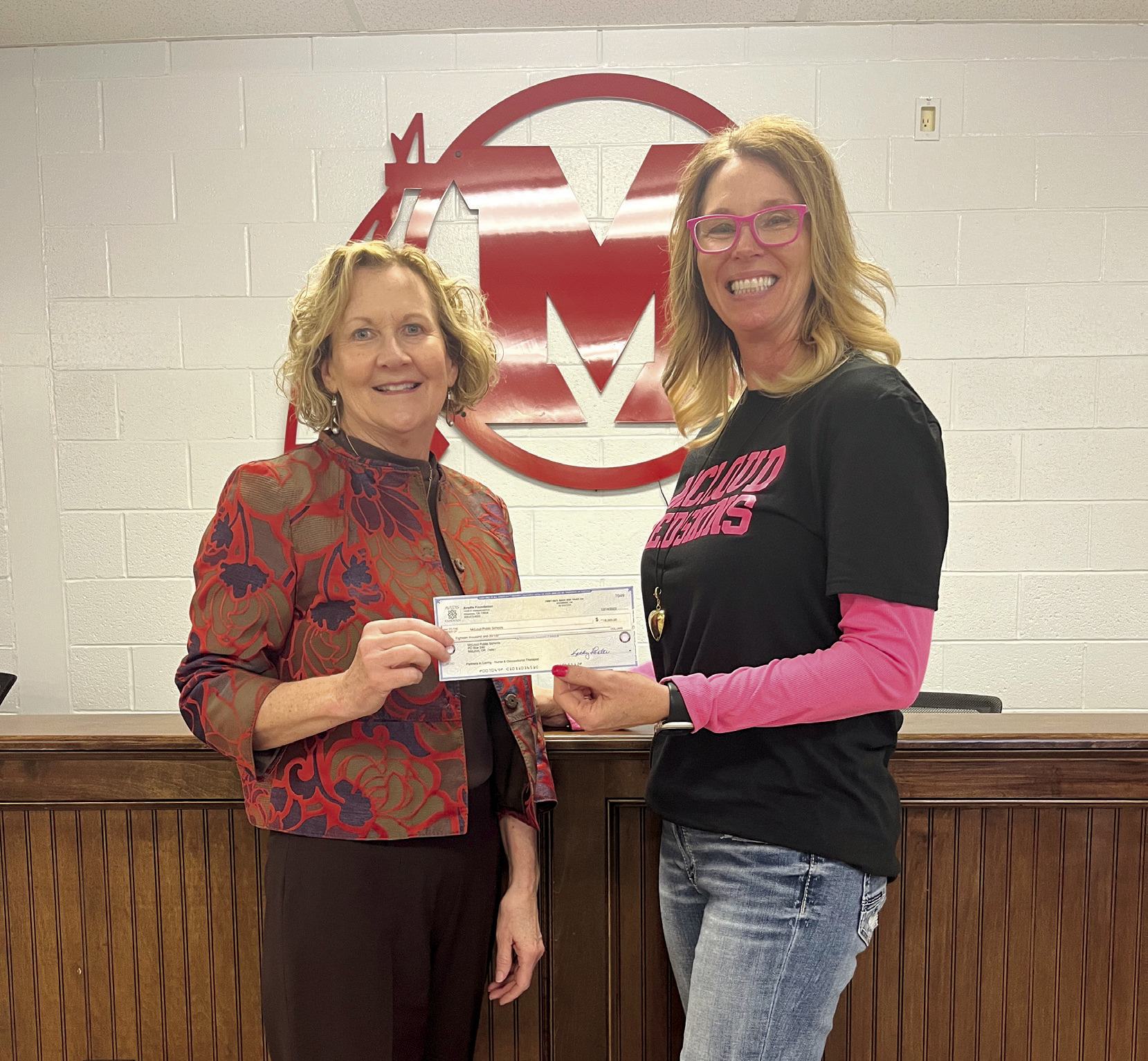 Audrey Seeliger, External Relations-Special Events for fhe Avedis Foundation, presents a check to Rhonda Hockenbury (left), Superintendent McLoud Public Schools. Photo provided
