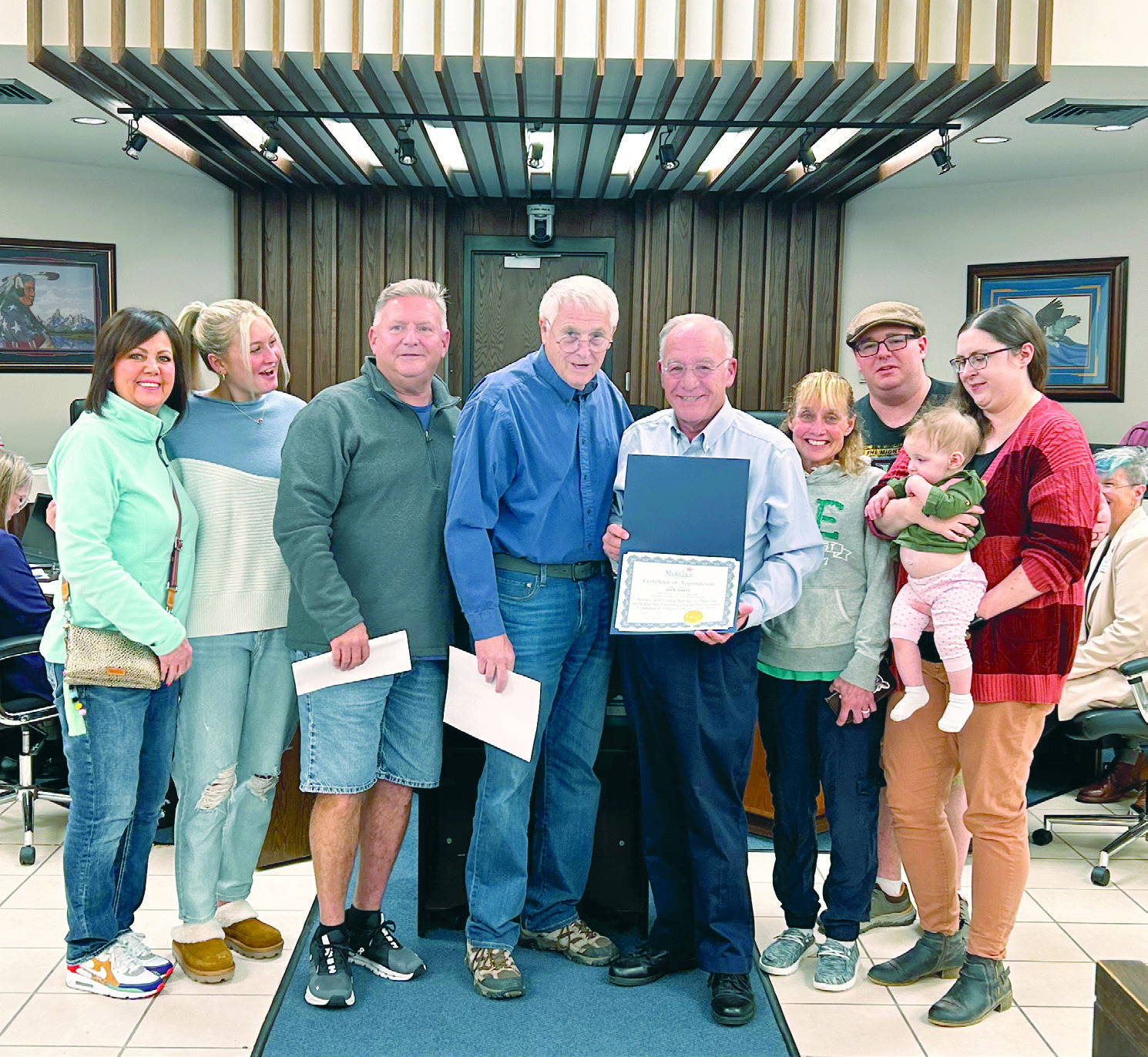 Mayor Ed Bolt presents a certificate of recognization to the family of Ann Davis who passed away in early Sept. Receiving the certificate is her son Trey surrounded by multiple family members. Countywide & Sun/Suzie Campbell