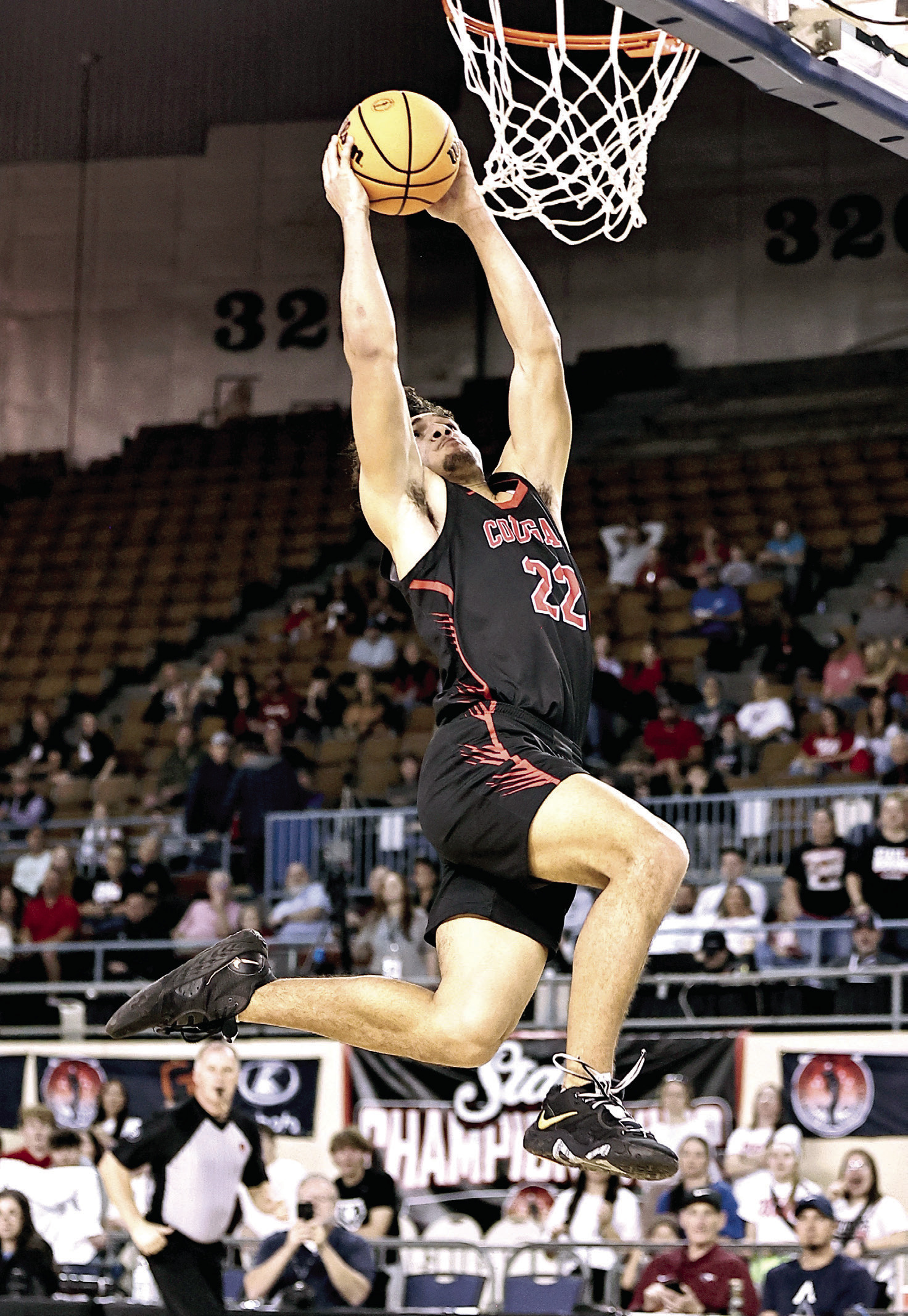 North Rock Creek's Caleb Hawkins goes up for the dunk. NRC won the first round of the State games, beting Bethany 61-56. The Cougars lost to Weatherford, 58-68, Friday, Mar. 14 in the semi-finals. Weatherford went on to claim the State Championship title. Photo courtesy of Gowin Photography