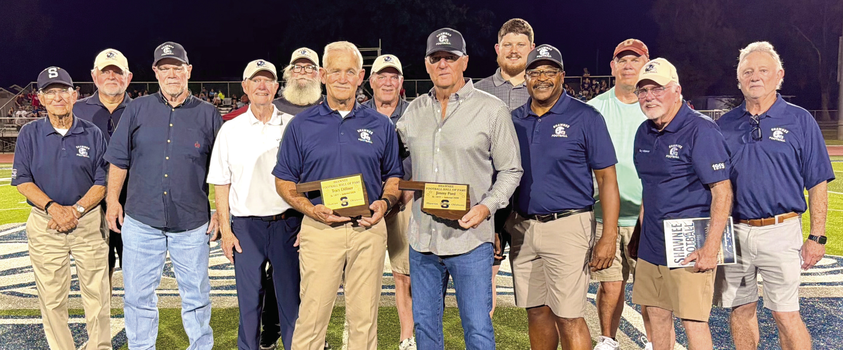 Shawnee Wolves alumni recognize new Hall of Fame Members, Tracy Dilliner and Jim Ford, both from the SHS Class of 1978, on the football field at halftime on Sept. 11. Shown, from left, are Bill Ford, Mike Hawkins, Dennis Brooks, Mike Sperry, Greg Petree, Dilliner, Chris Reynolds, J. Ford, Tristan Wyatt, Timmy Young, Gary Williamson and Kelly Parsons. Photo provided by Shawnee Public Schools