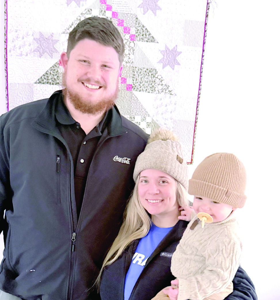 Tristan Wyatt poses with his wife, Bailey and son William.