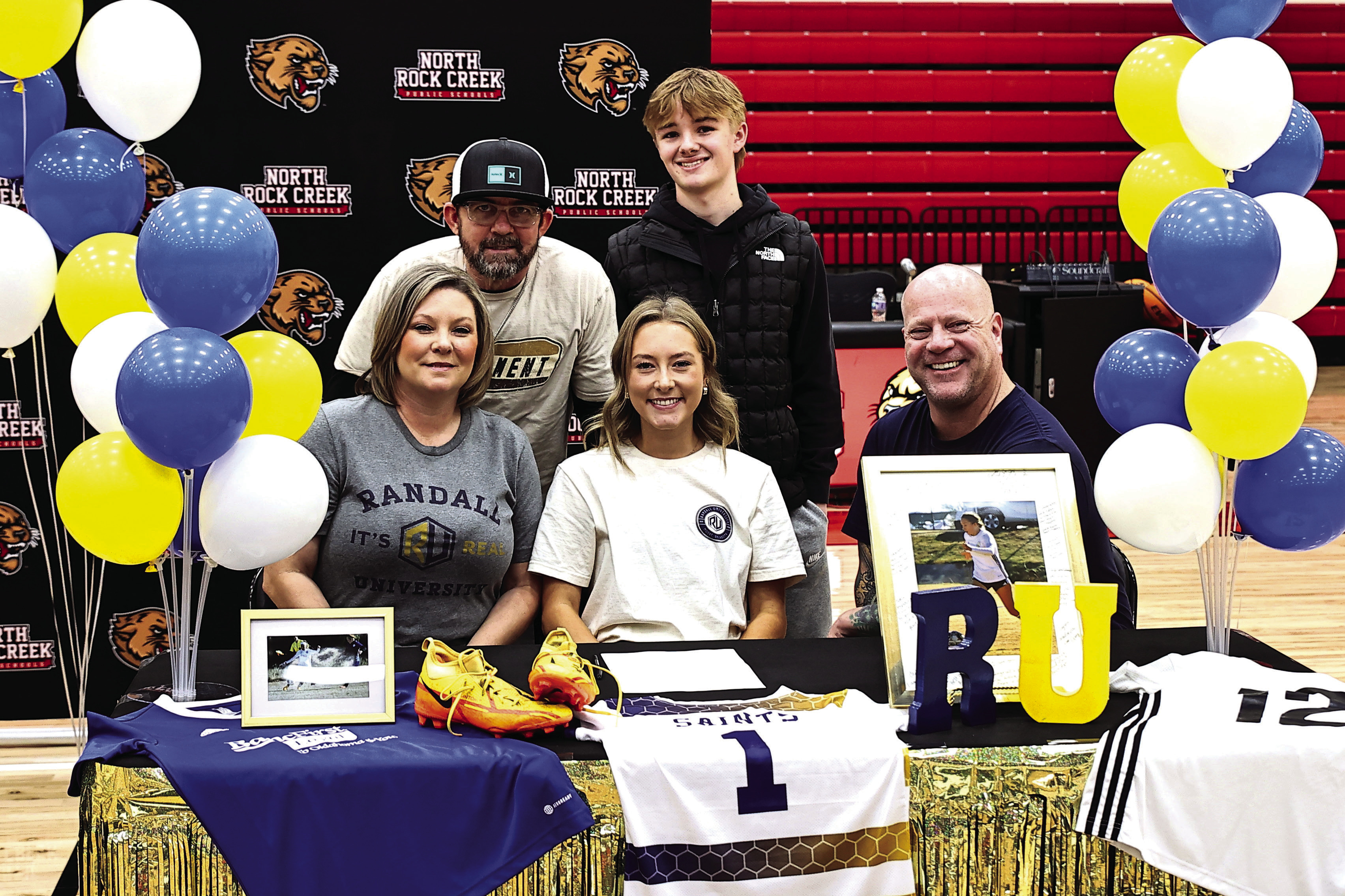 Pictured left, North Rock Creek’s Caitlin Walls signed her letter of intent to attend Randall University next year to play soccer. Watching her was her family, David Walls, Donny &amp; Alisha Armitage, and Bronson Armitage. Photo courtesy of Gowin Photography