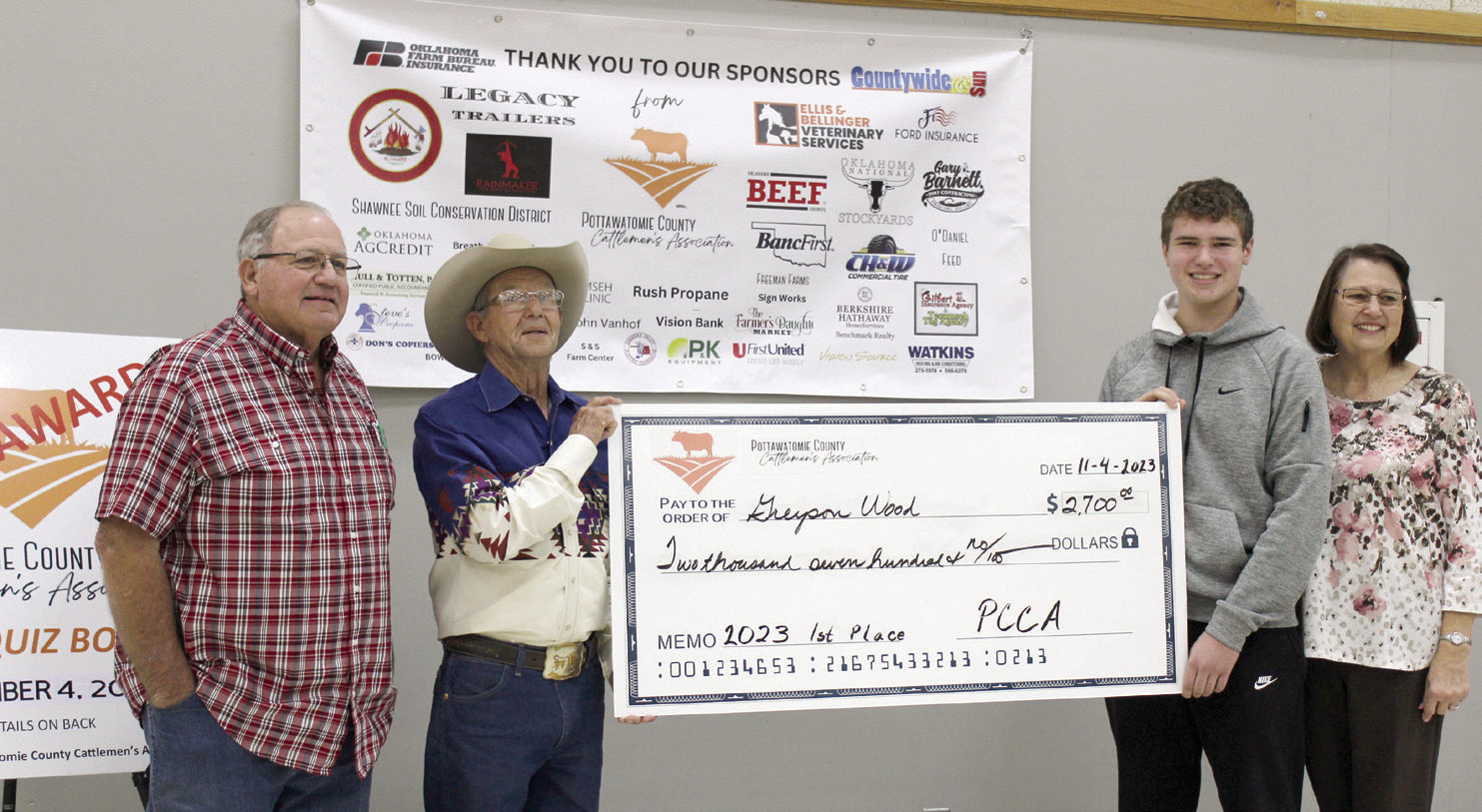 Greyson Wood of Dale poses with a display check for $2,700 after winning first place in the Second Annual Pottawatomie County Cattlemen's Association Beef Quiz Bowl on Nov. 4. Also shown are Wood's grandfather, Steven Rasure, far left, PCCA President Bob Freeman, and grandmother, Deborah Rasure, far right. Wood received a $200 bonus since his grandparents are members of the PCCA. Second place went to Stephen Wickard of North Rock Creek, and third place went to Austin Ramsey of Tecumseh.