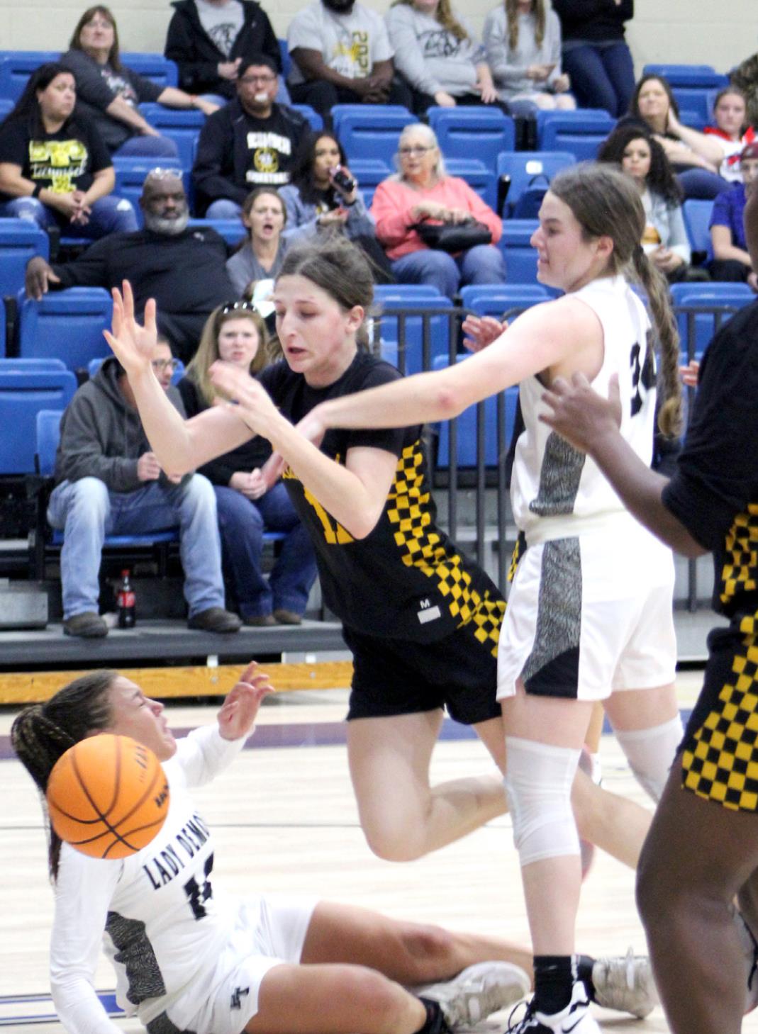 Tecumseh’s Kenzli Warden has the ball knocked out of her hands by one Perkins-Tryon defender and nearly trips on another on her way to the basket during the First United Bank Classic consolation championship round in Bethel on Dec. 11. The Lady Savages won that game, 39-35. They lost to Byng in the first round on Dec. 9, 37-54, and won against Bridge Creek, Dec. 10, 74-32. Countywide &amp; Sun/Natasha Dunagan