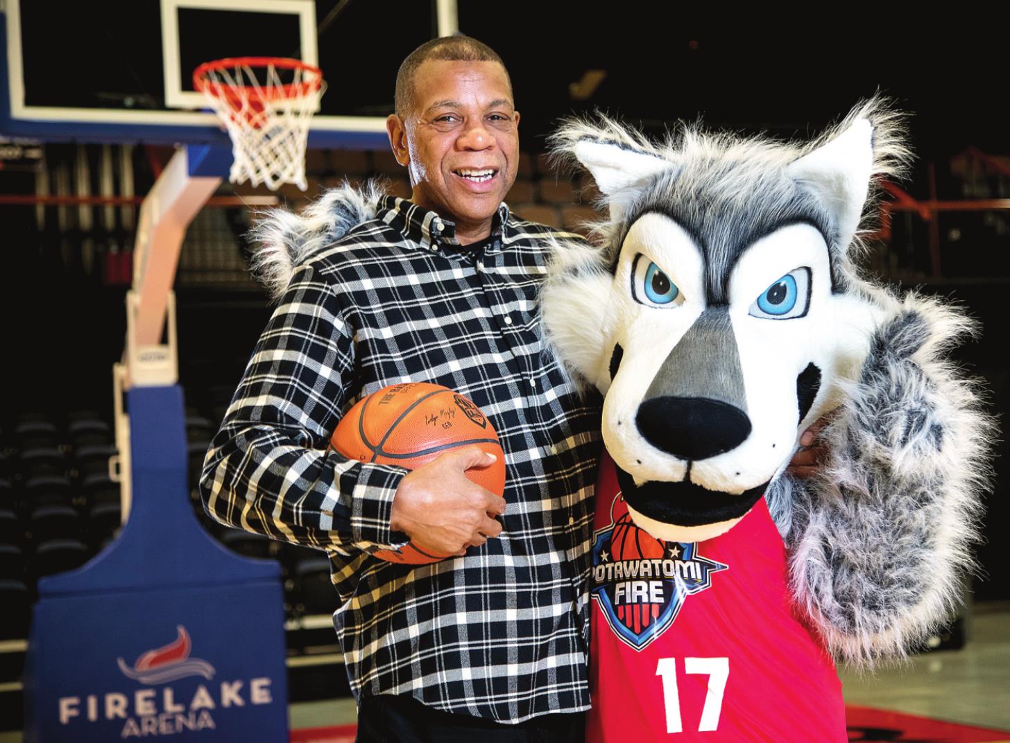Potawatomi Fire Head Coach Derrick Rowland poses with Mo’ewé, or Mo, the team mascot. Mo’ewé (Mo-Eh-Weh) is the Potawatomi word for wolf. Photo provided by CPN