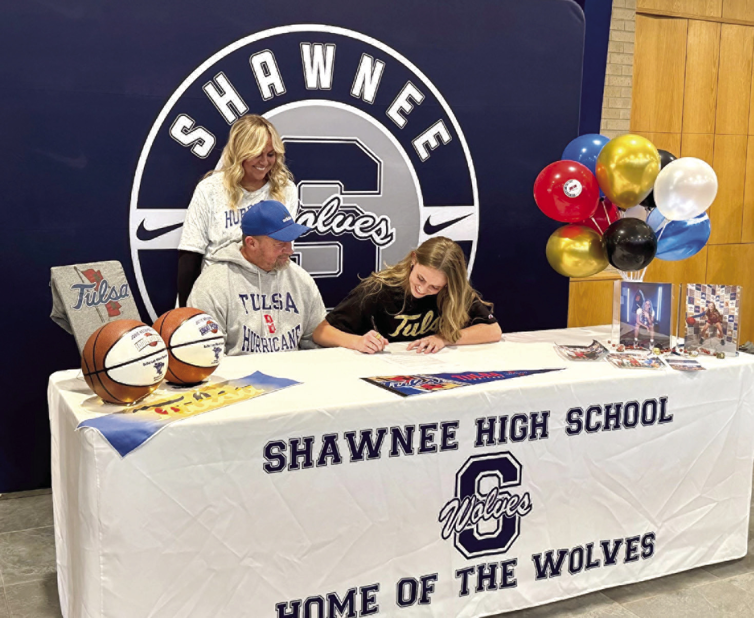 Shawnee senior Josie Megehee signs a letter of intent with the University of Tulsa to play basketball in Division 1 of the American Athletic Conference on Nov. 29. Megehee is pictured with parents, Brandon and Leslie Megehee. Photo provided by Amanda Johnson.
