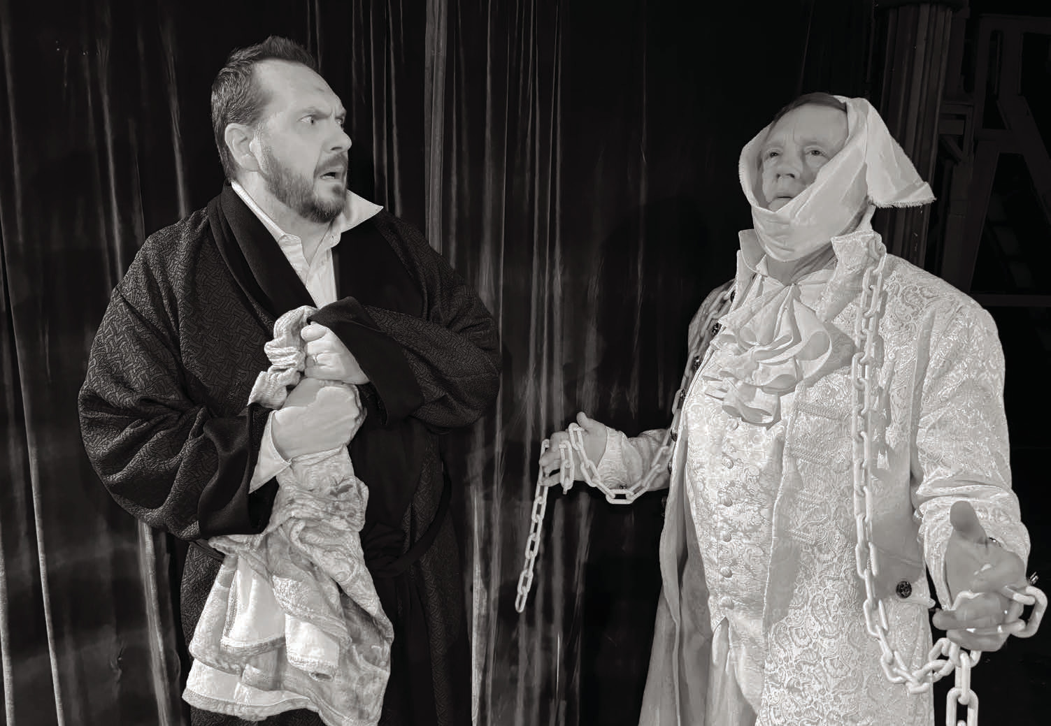 Scott Bartley (Ebinezer Scrooge) is frightened when he is visited by Robert Benton (a ghost of Christmas) in Shawnee Little Theatre’s production of “A Christmas Carol.” Photo provided by SLT